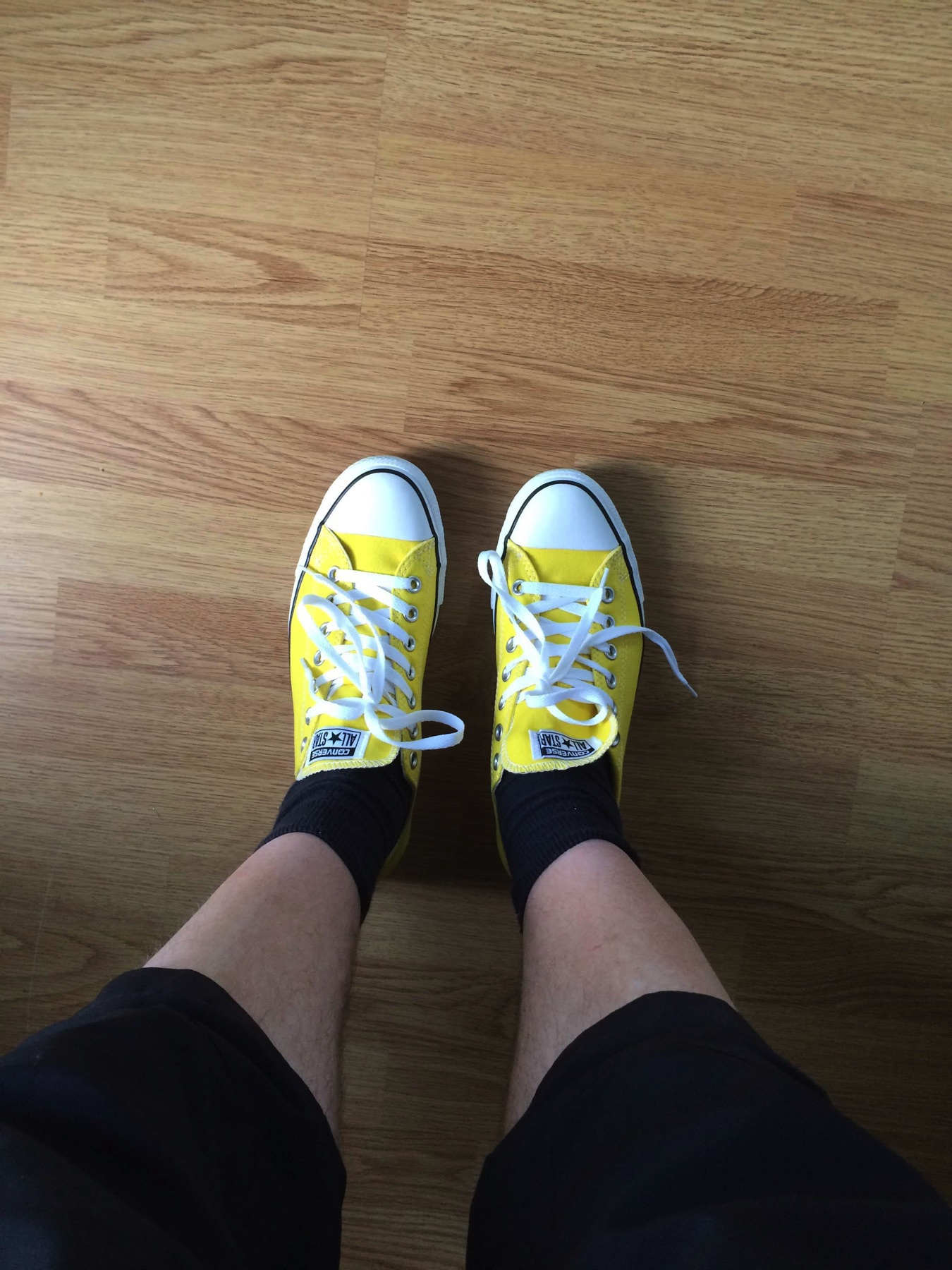 yellow converse all stars, floor, two feet