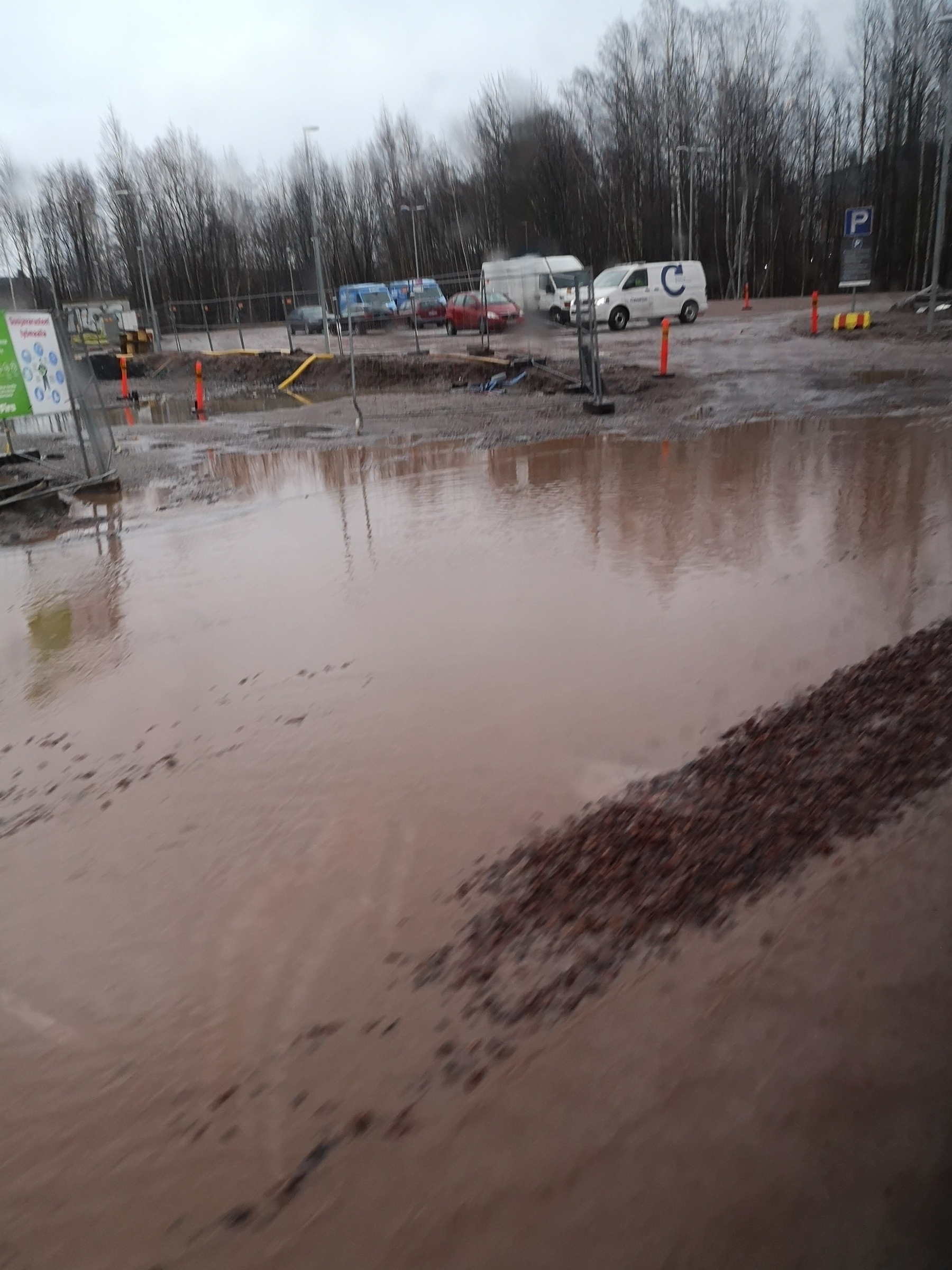 road covered in muddy water in Otaniemi, Espoo