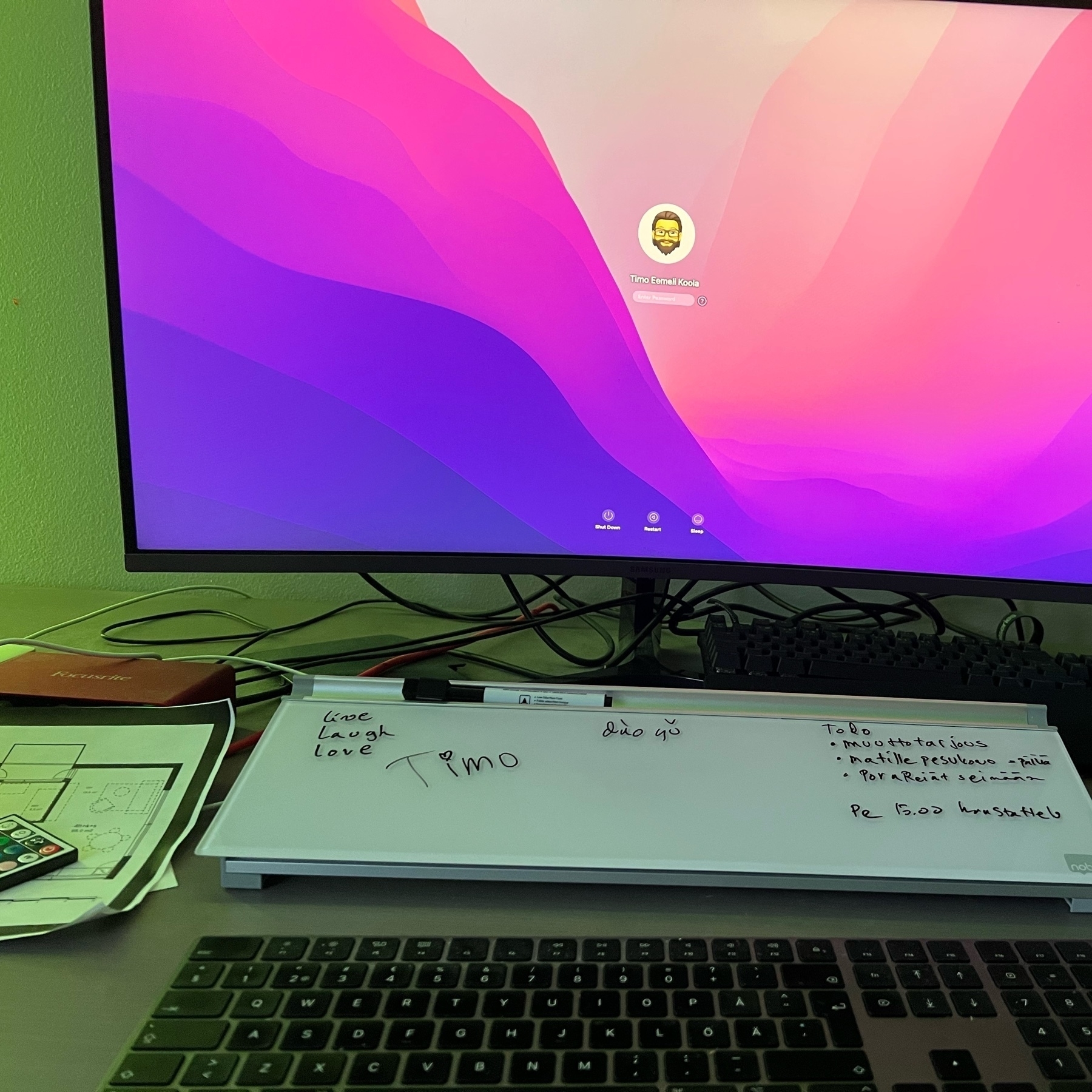 screen showing a login screen of macos and a Nobo desktop whiteboard under it