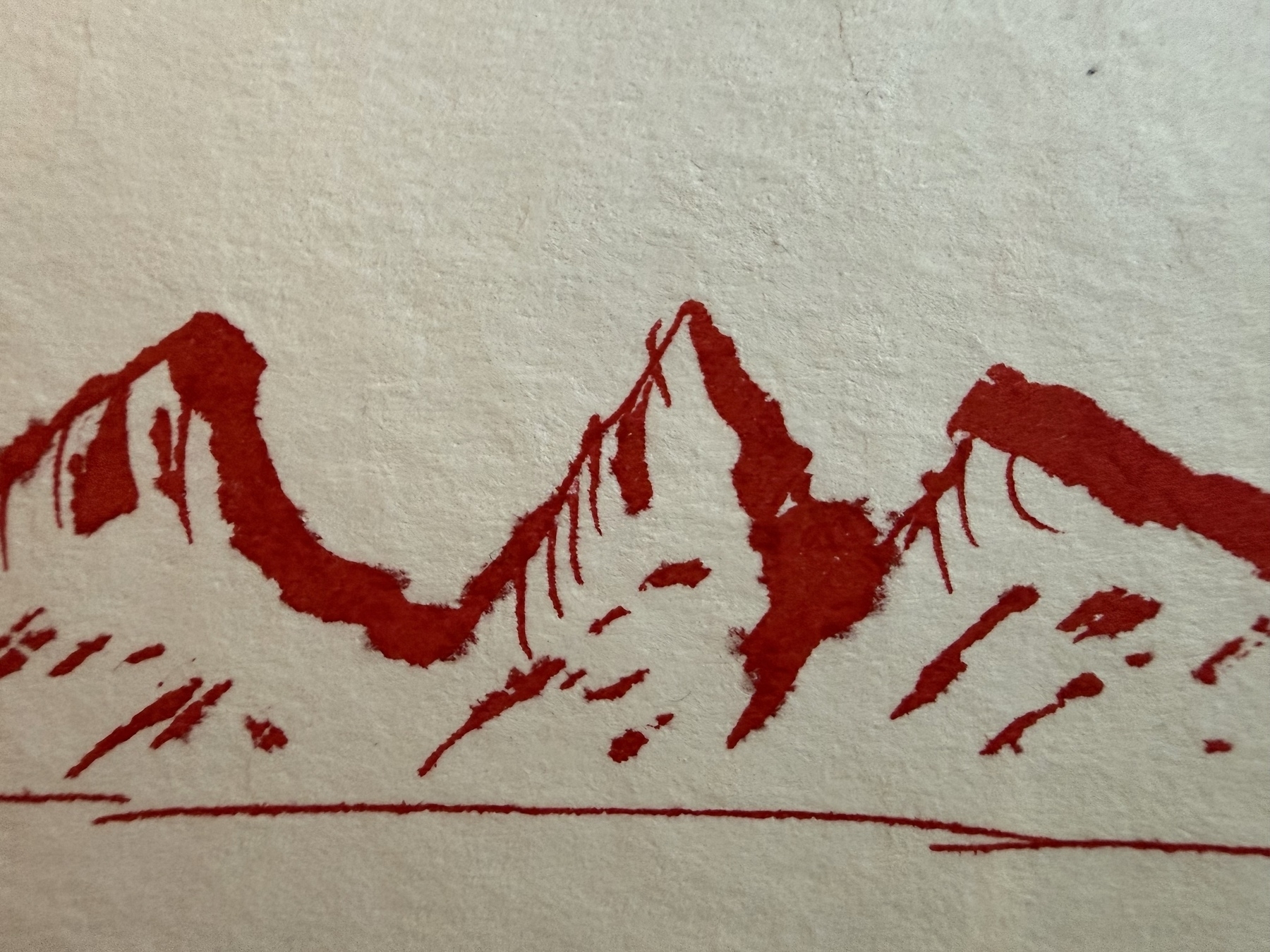 Very rough mountain range in red ink on a water colour paper