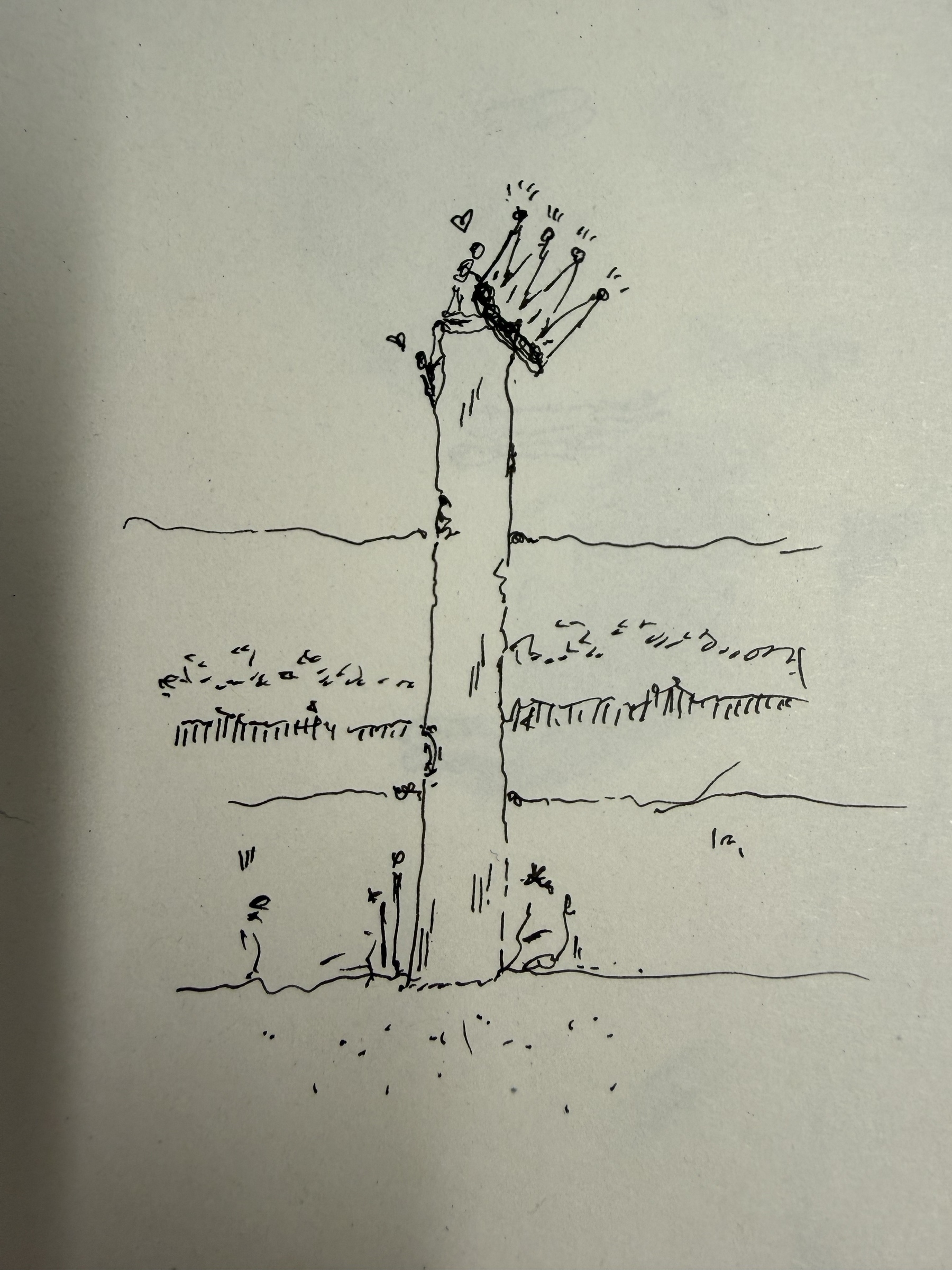 A febce pole by the edge of a field. There is a crown hanging at the top of pole and there are two miniature people trying to drop the crown down