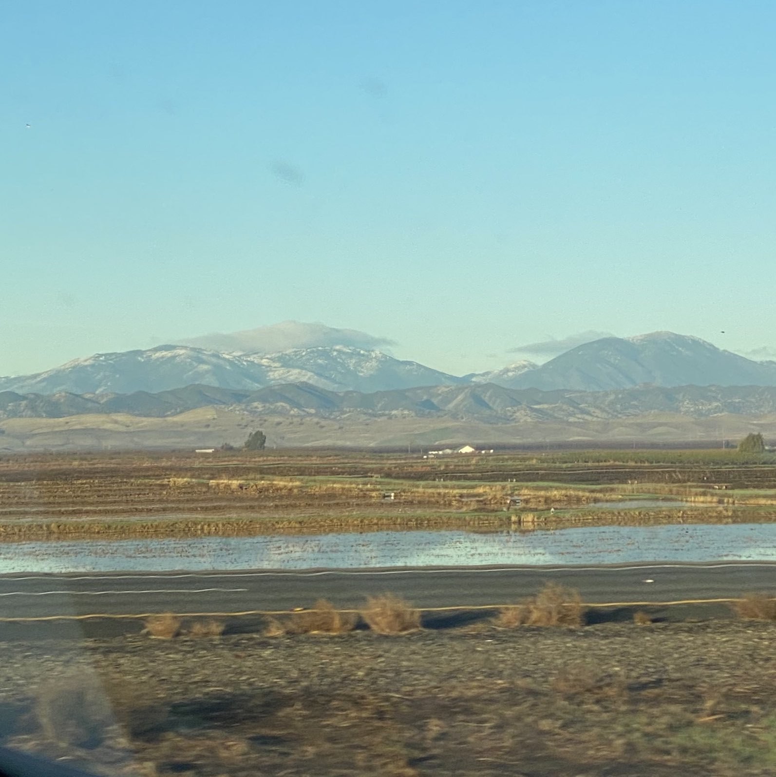 snowy mountain tops along a highway