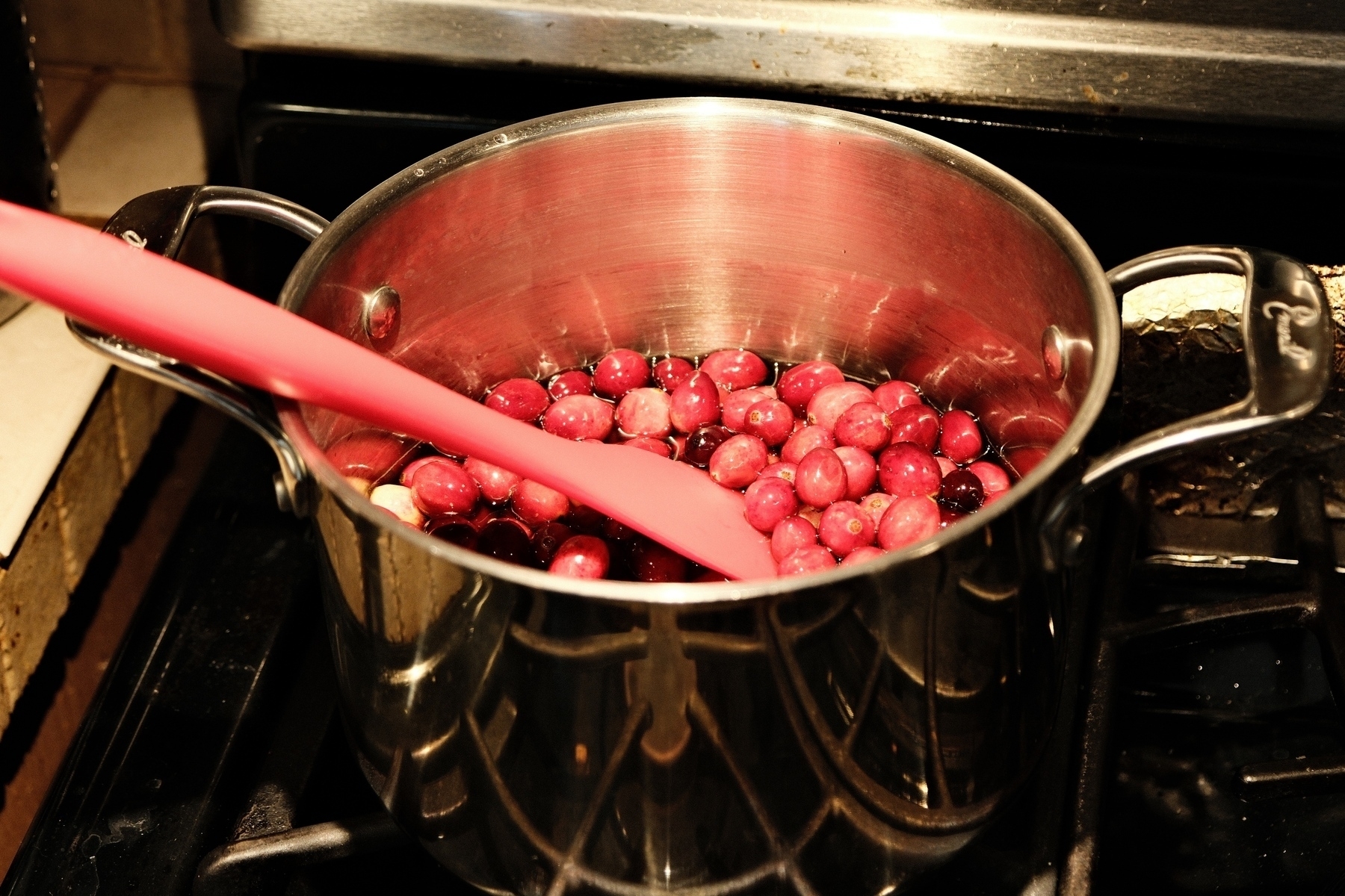 Whole cranberries in pot waiting to be cooked down into sauce.