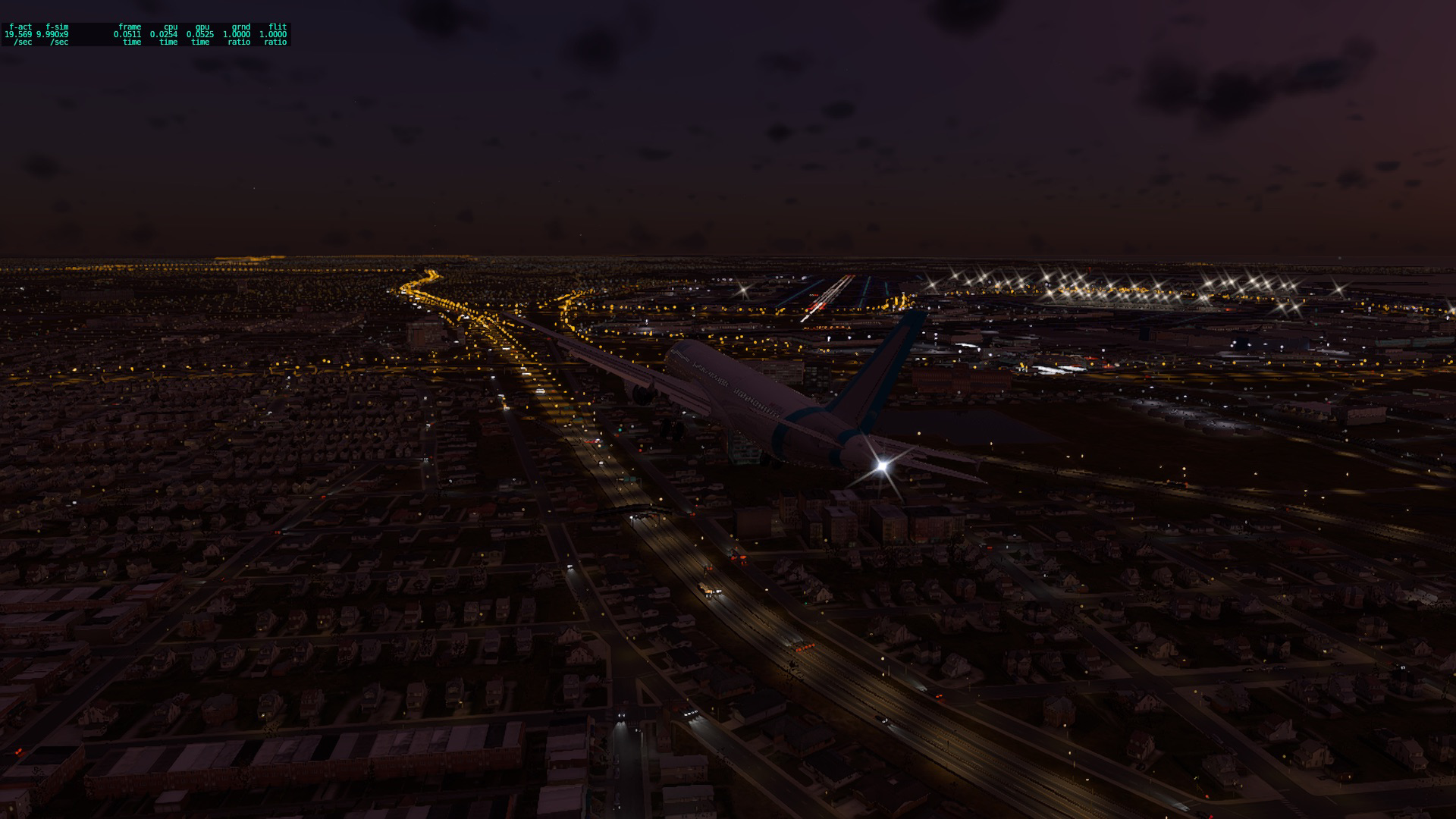 A321 on approach to KJFK 13L at night. Highways with cars, the street lights, and more all glow amber and white. The runway is visible and the jet is makiing a sharp turn for it.
