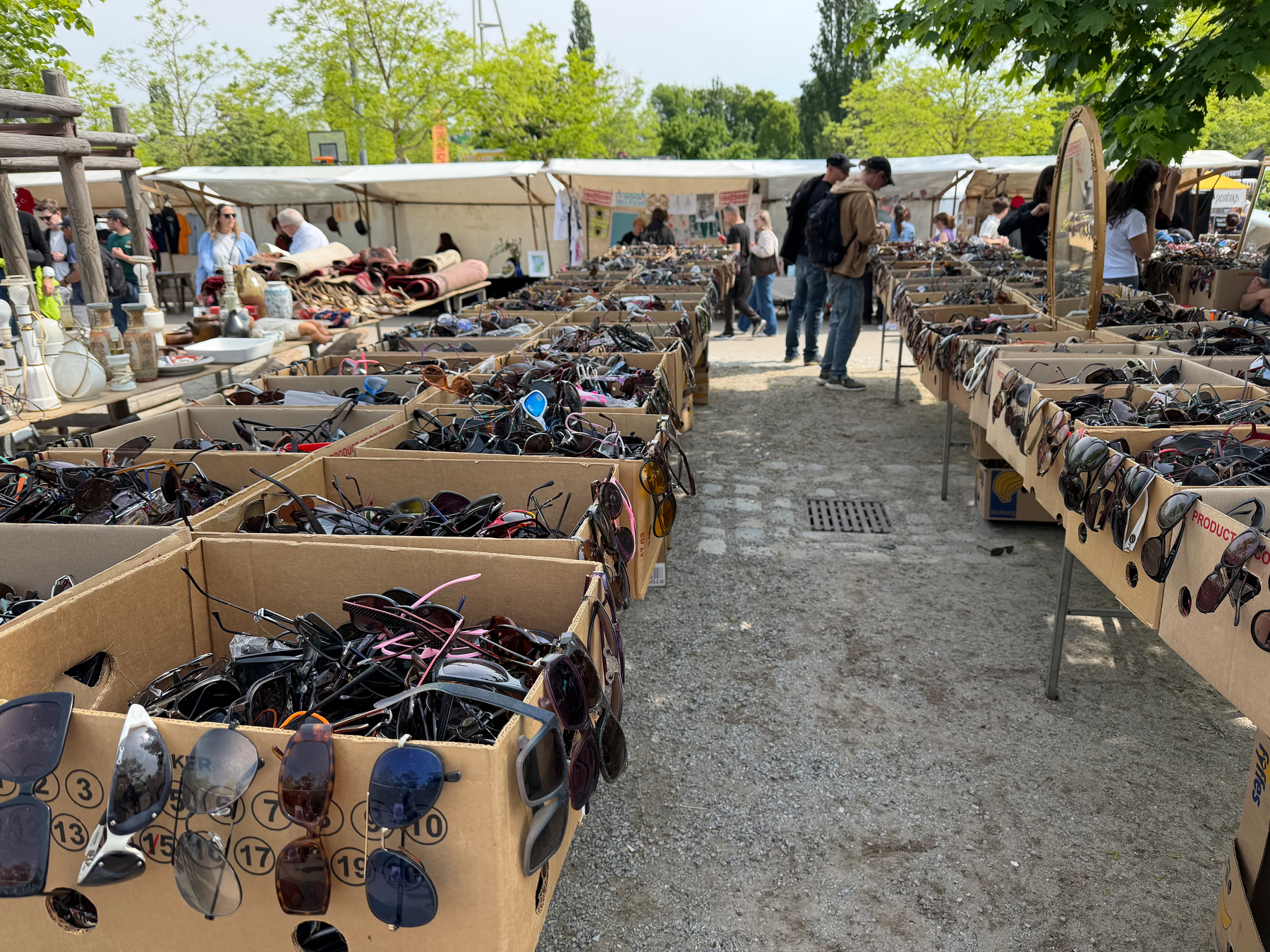 Rows of boxes of sun glasses on tables. Endless. 