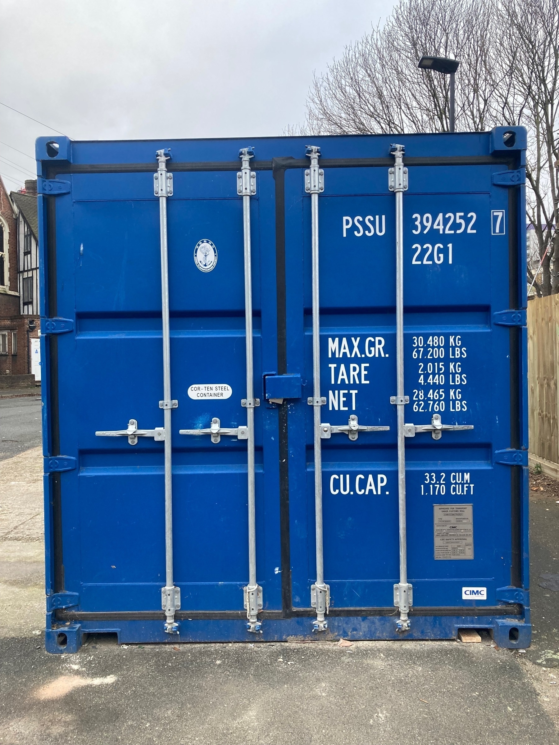 Picture of a blue shipping container holding builders materials and tools at a regeneration site in Canning Town, East London, UK
