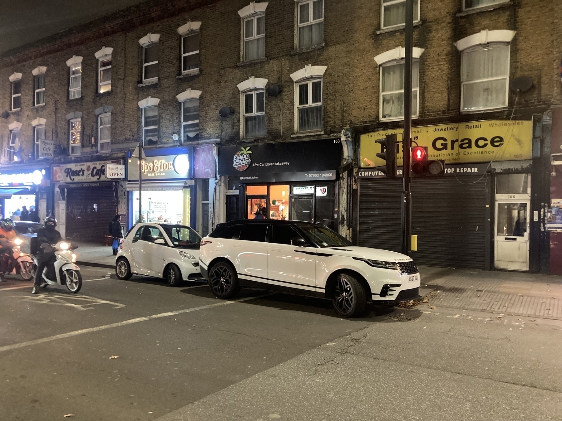 A white SUV is illegally parked on a crossing in East London