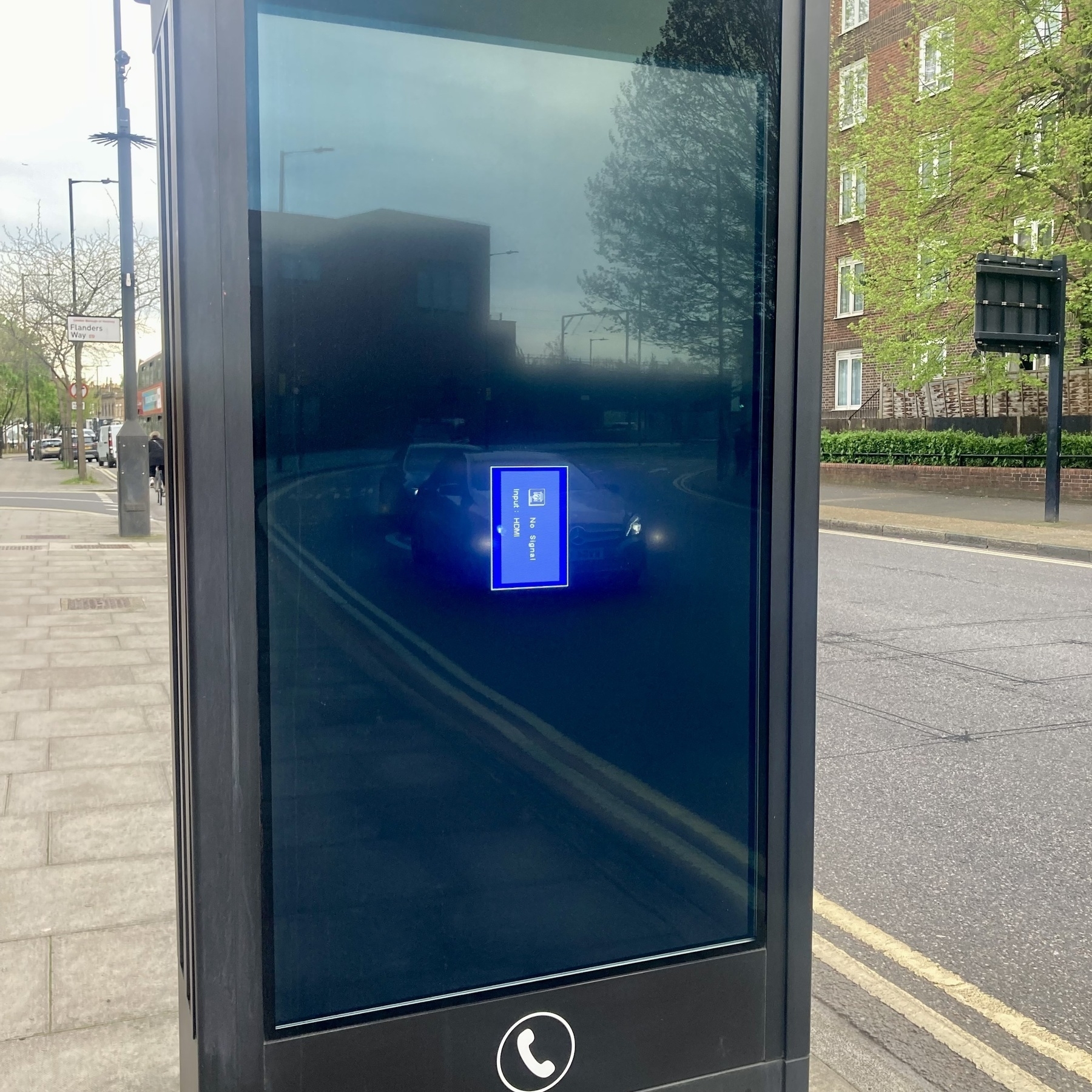 A digital advertising screen shows an input error