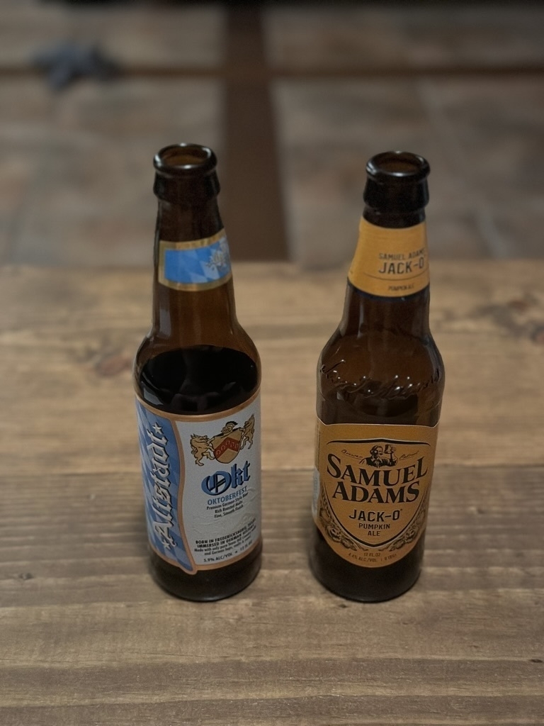 Two beer bottles on a table: Altstadt Okt and Samuel Adams Jack-O