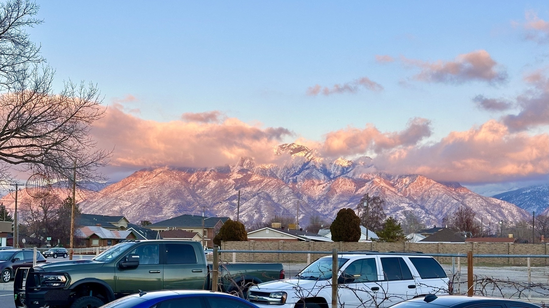 Mountain ridge with pink coloring on the peaks from the sunset.