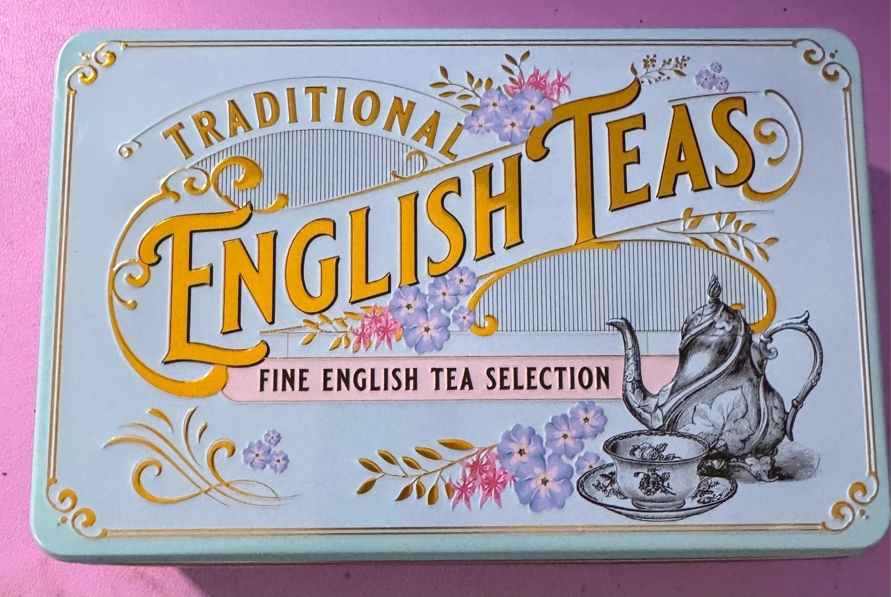 Light blue rectangle canister with the word English tea in raised lettering 