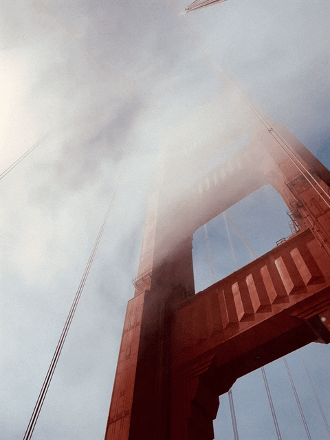 photo loop of clouds passing by a tower of the Golden Gate Bridge