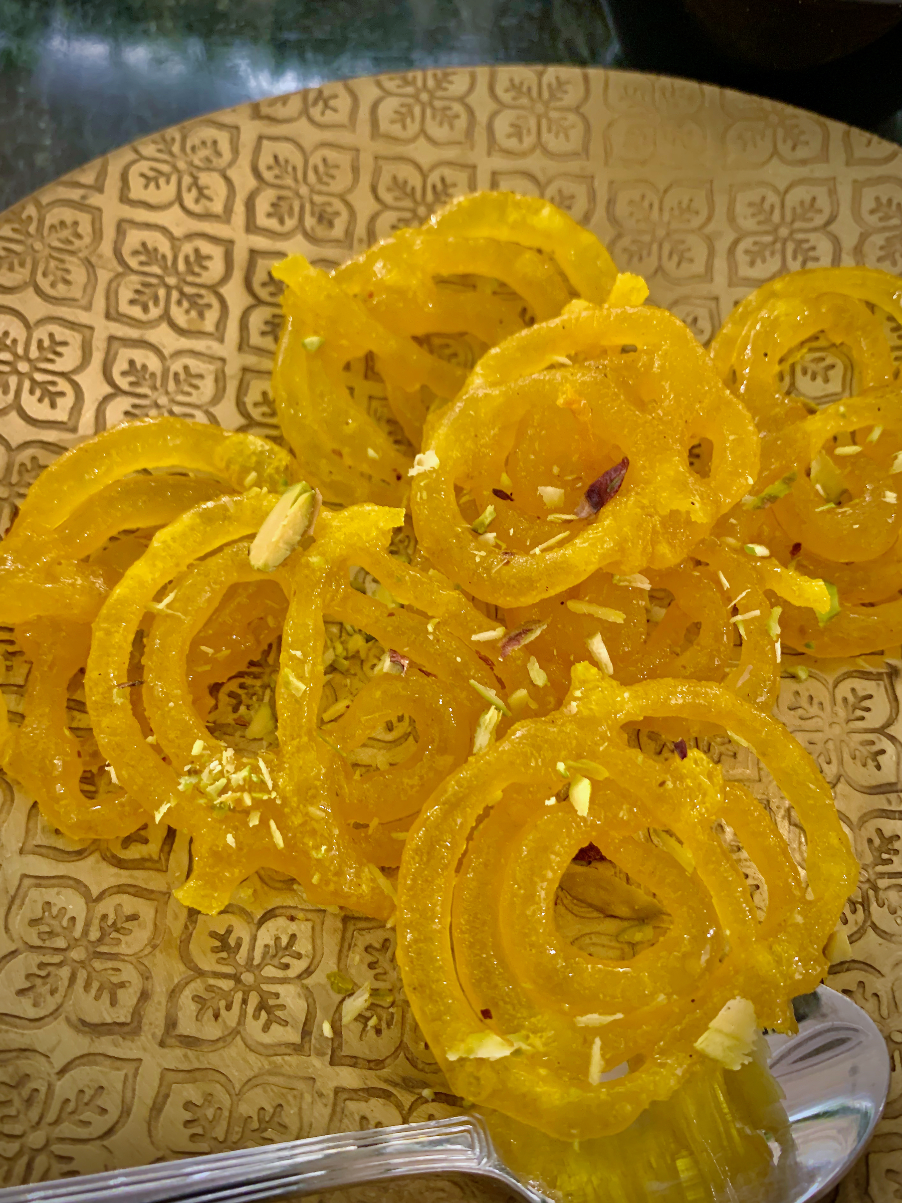 A plate of jalebis in chrome yellow colour