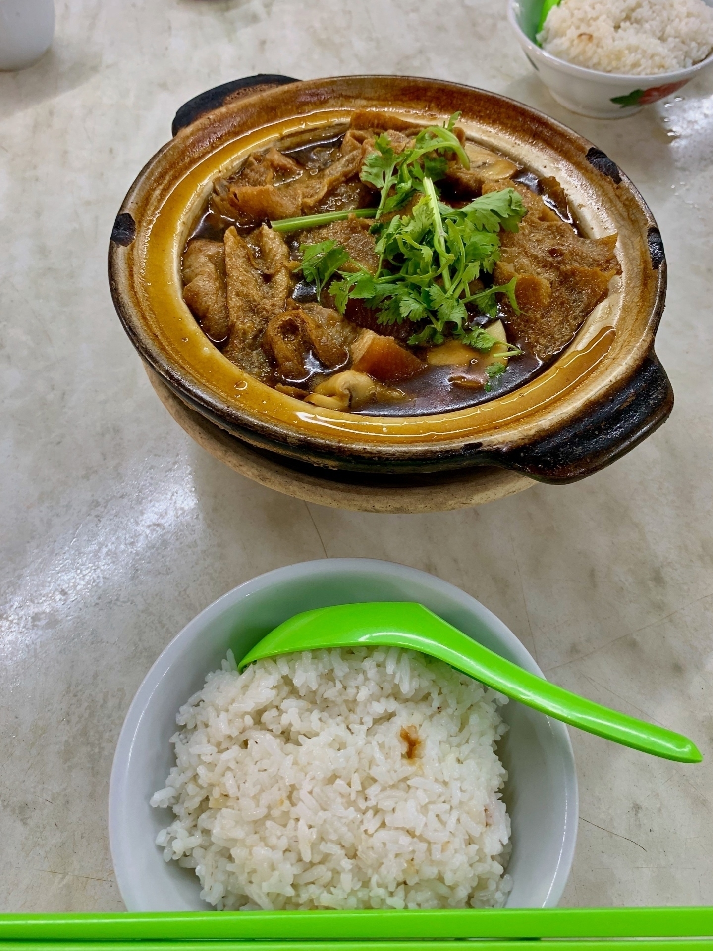 A claypot full of a pork broth dish called Bak kut teh, along with a bowl of plain rice