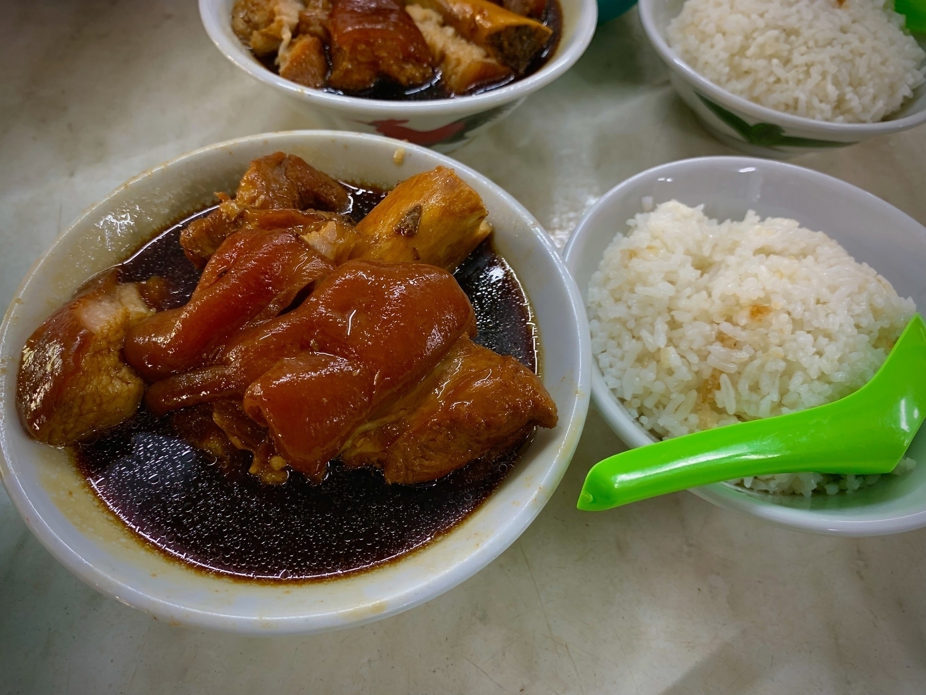 Pork knuckle in Bak kut teh broth along with a bowl of rice