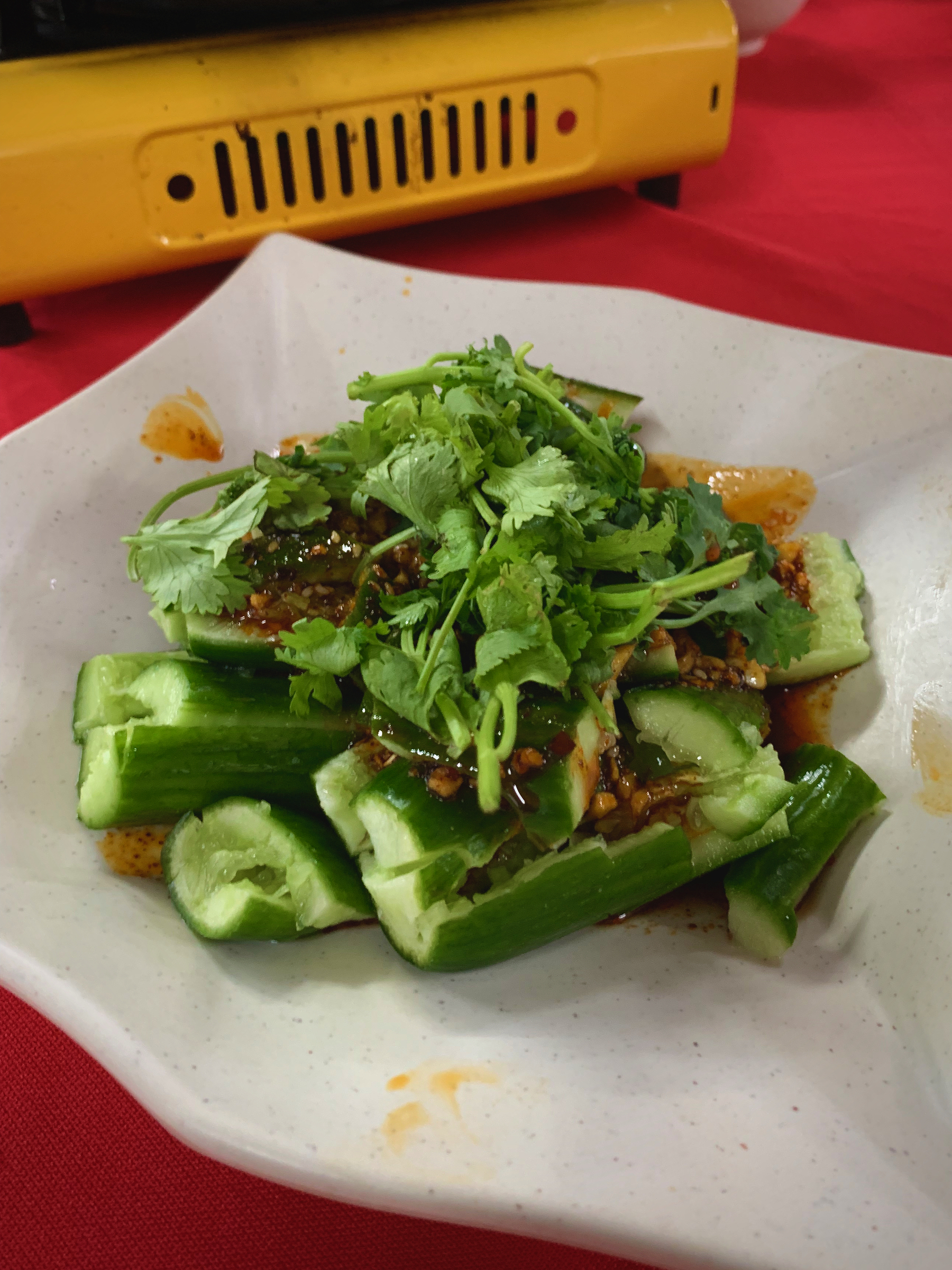 Cucumber smashed and spiced with some chilli oil