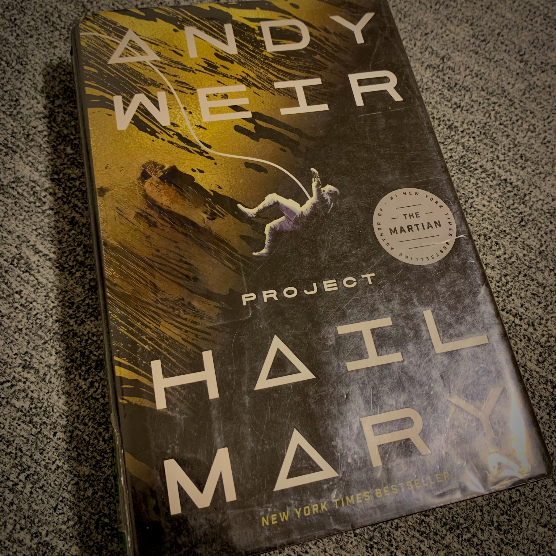 Auto-generated description: A book titled Project Hail Mary by Andy Weir is displayed, featuring a stylized space-themed cover with a recommendation from The Martian.