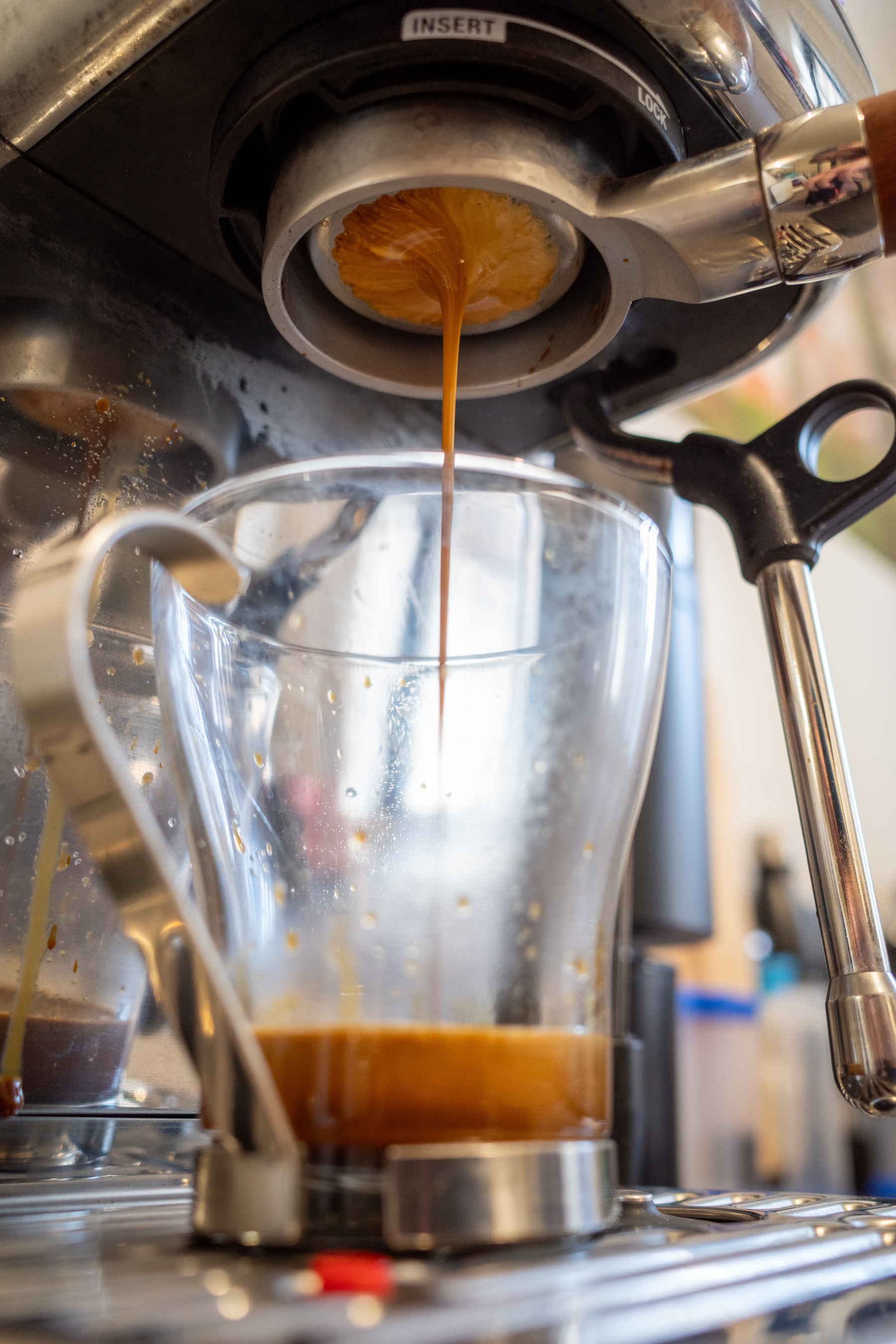 Espresso coffee being extracted through a naked portafilter