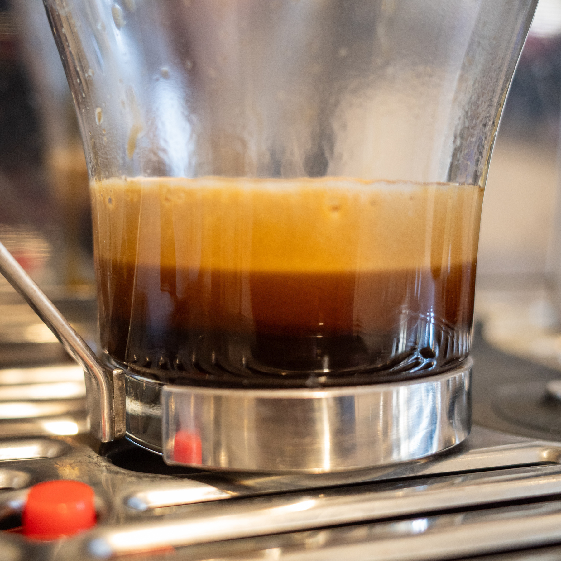 The multiple layers of espresso coffee settle in a glass