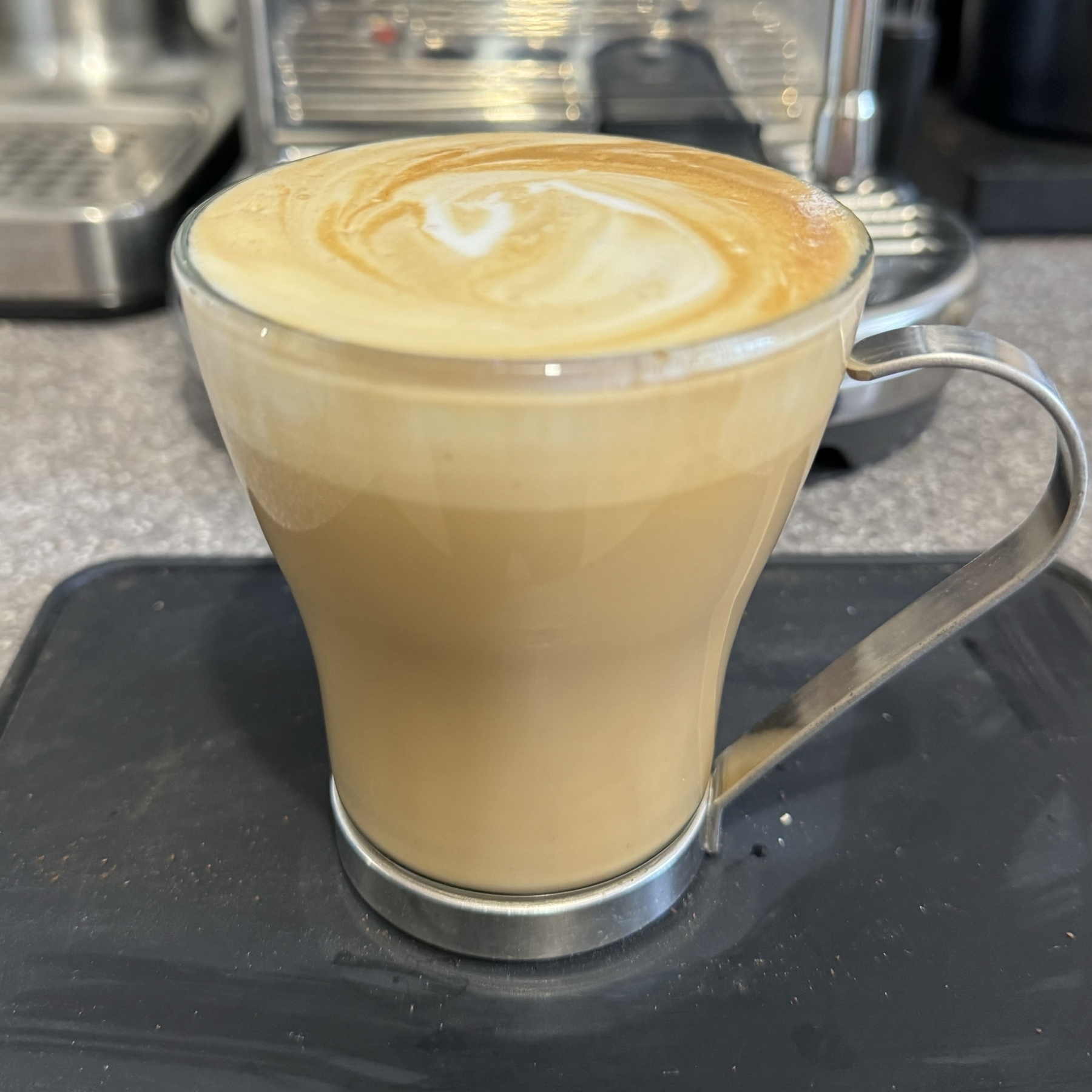 Flat white coffee in a glass mug