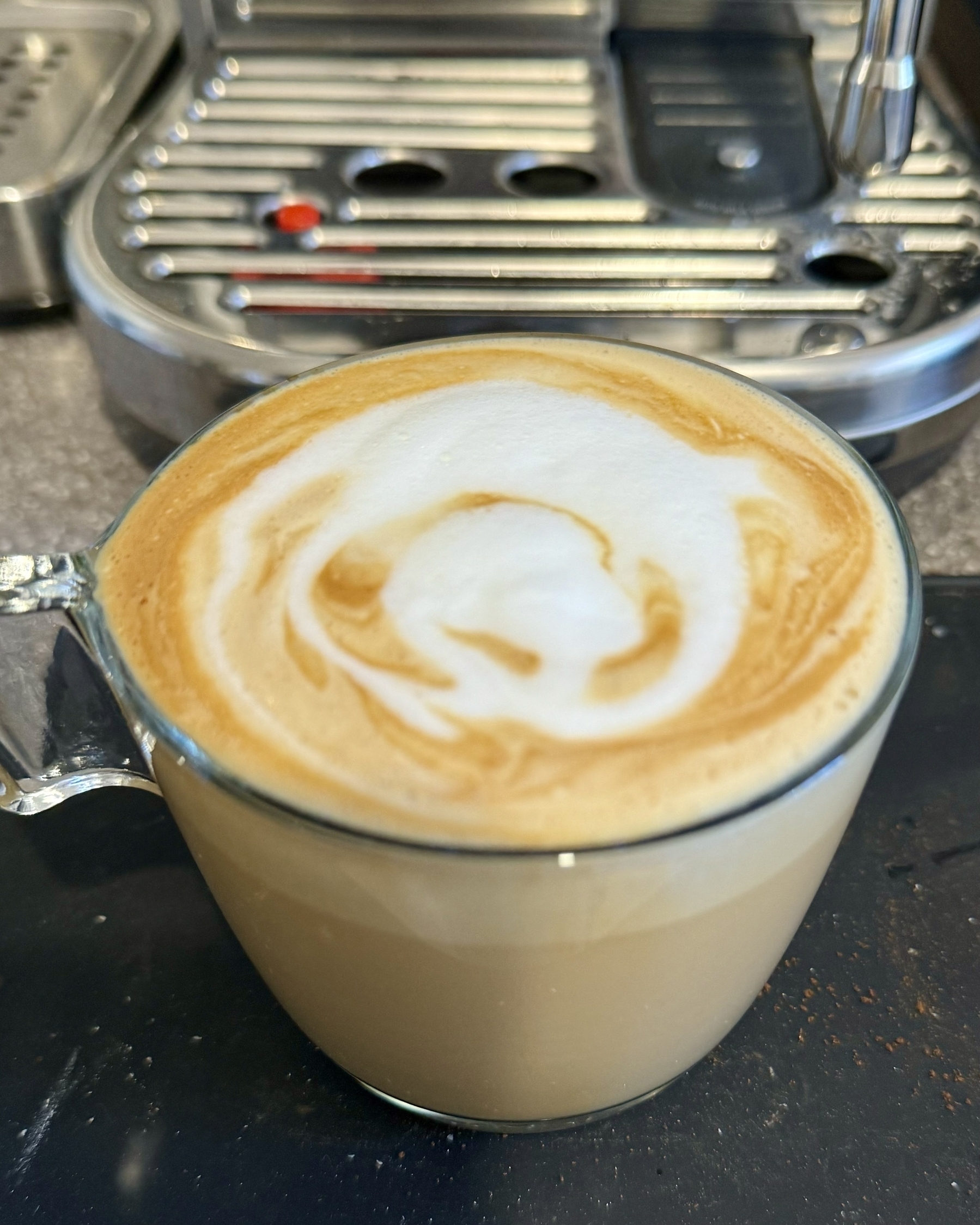 Flat white coffee in a glass mug