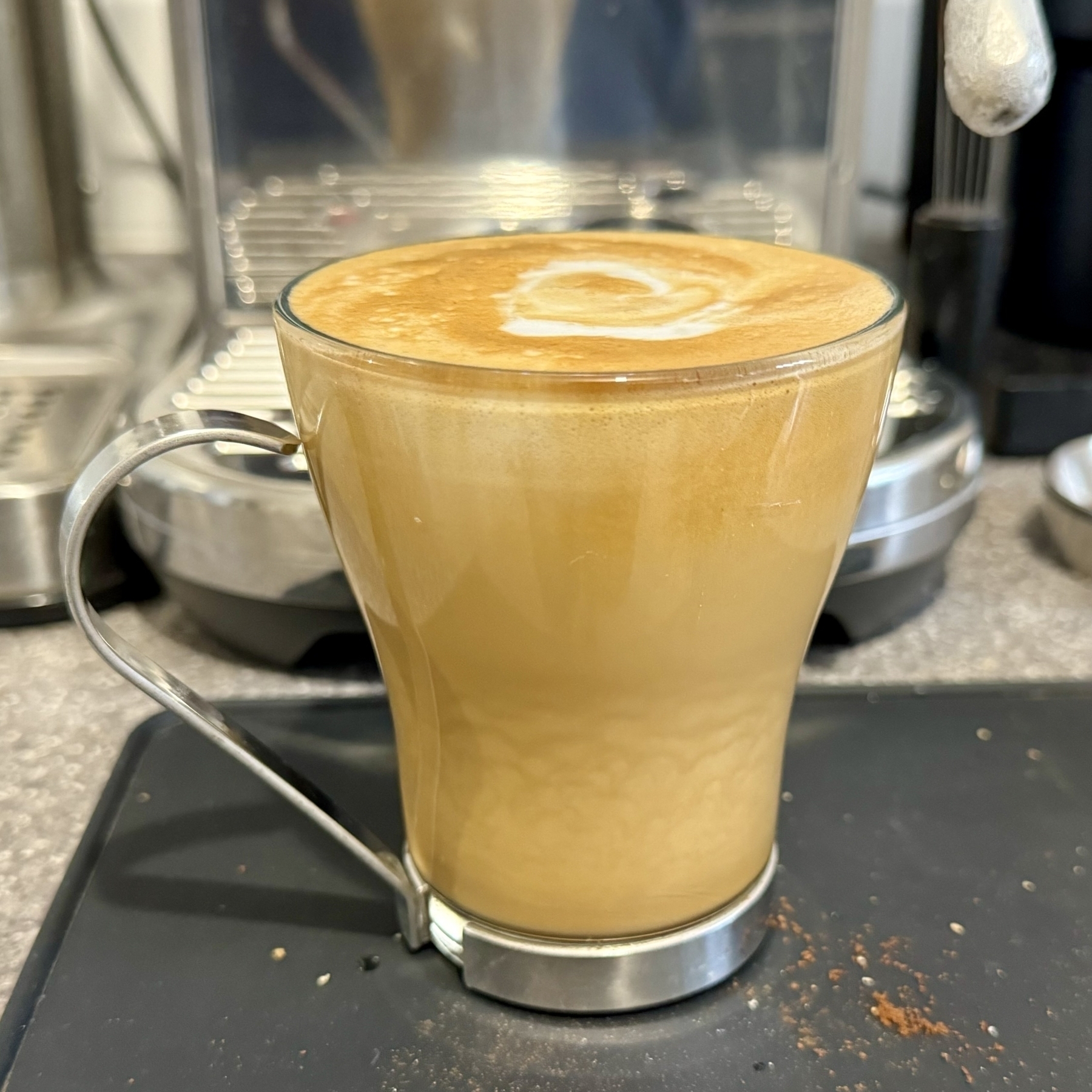 Flat white coffee in a glass mug