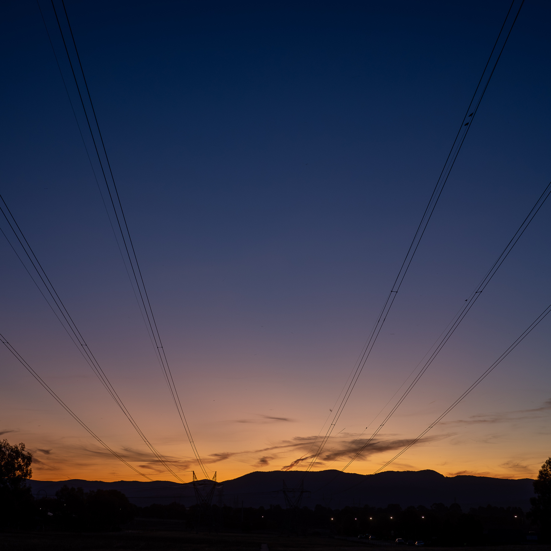 Later sunset, now a deep orange over the mountains with a darker blue sky.