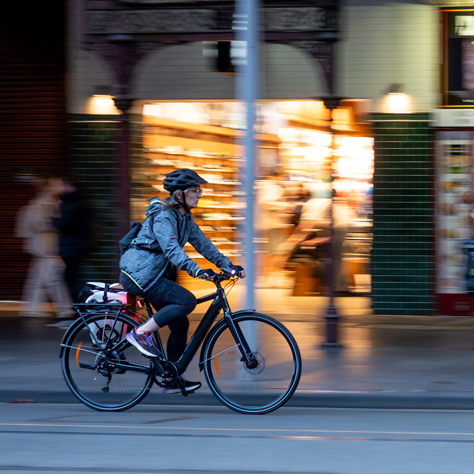 A cyclist commuting along Swanston St