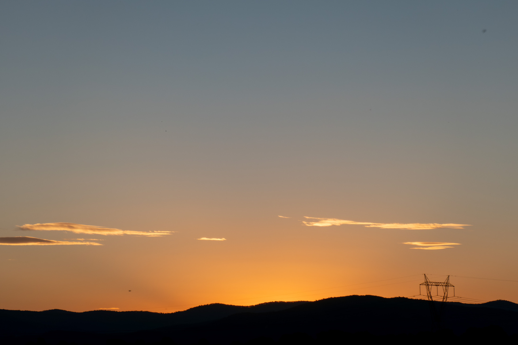 A sunset. Orange to light blue glow with some very small thin clouds above the horrizon.