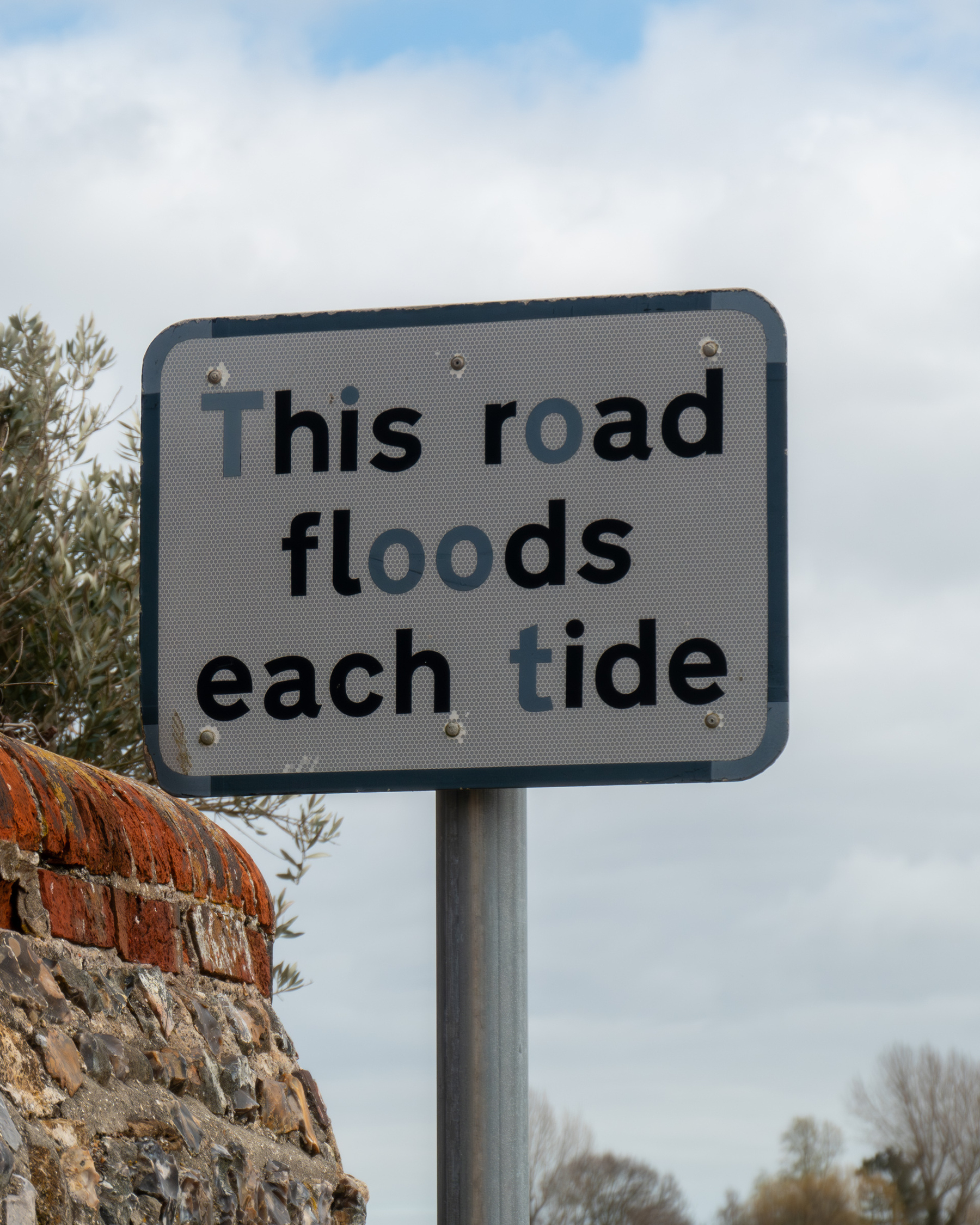 Road sign - this road floods each tide.