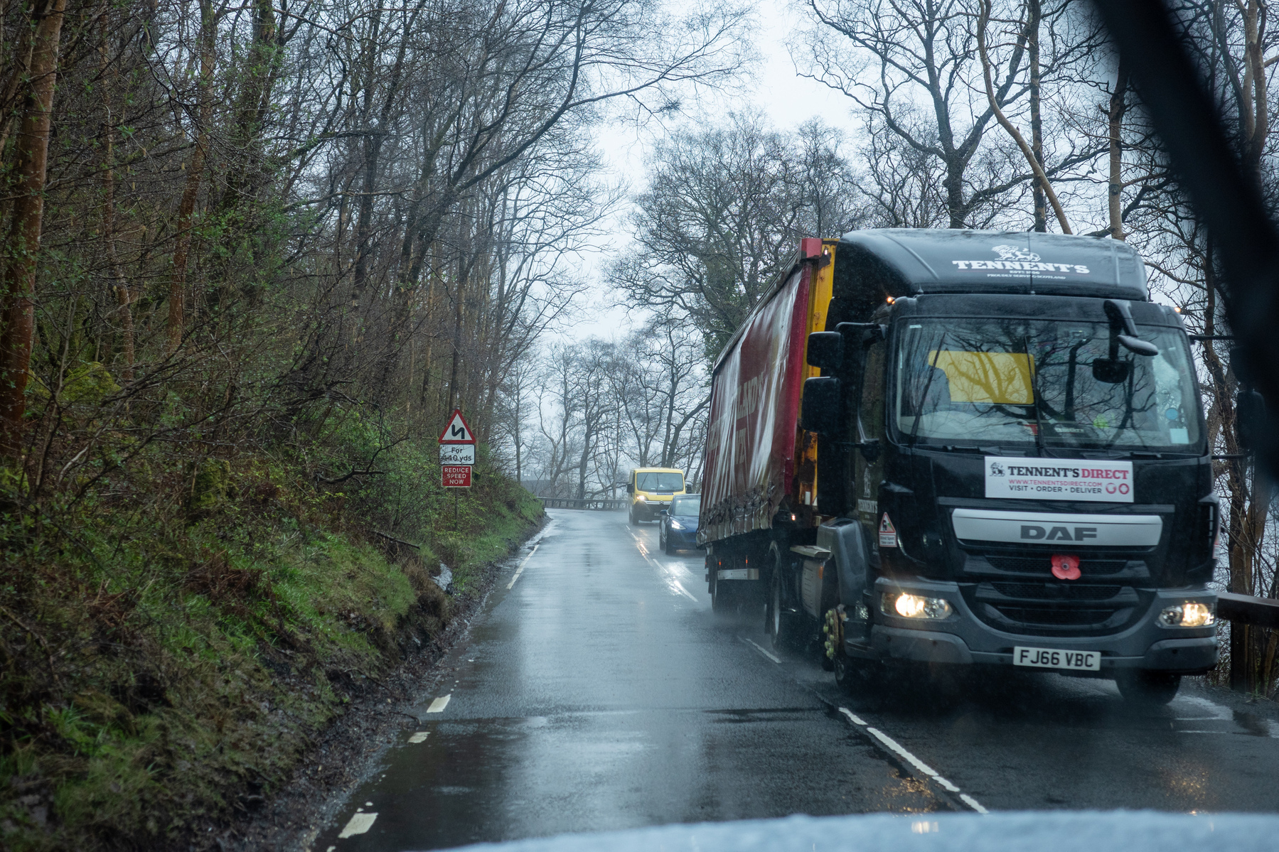 Rainy road - A82. There is a large truck and other vehicles coming the other way.
