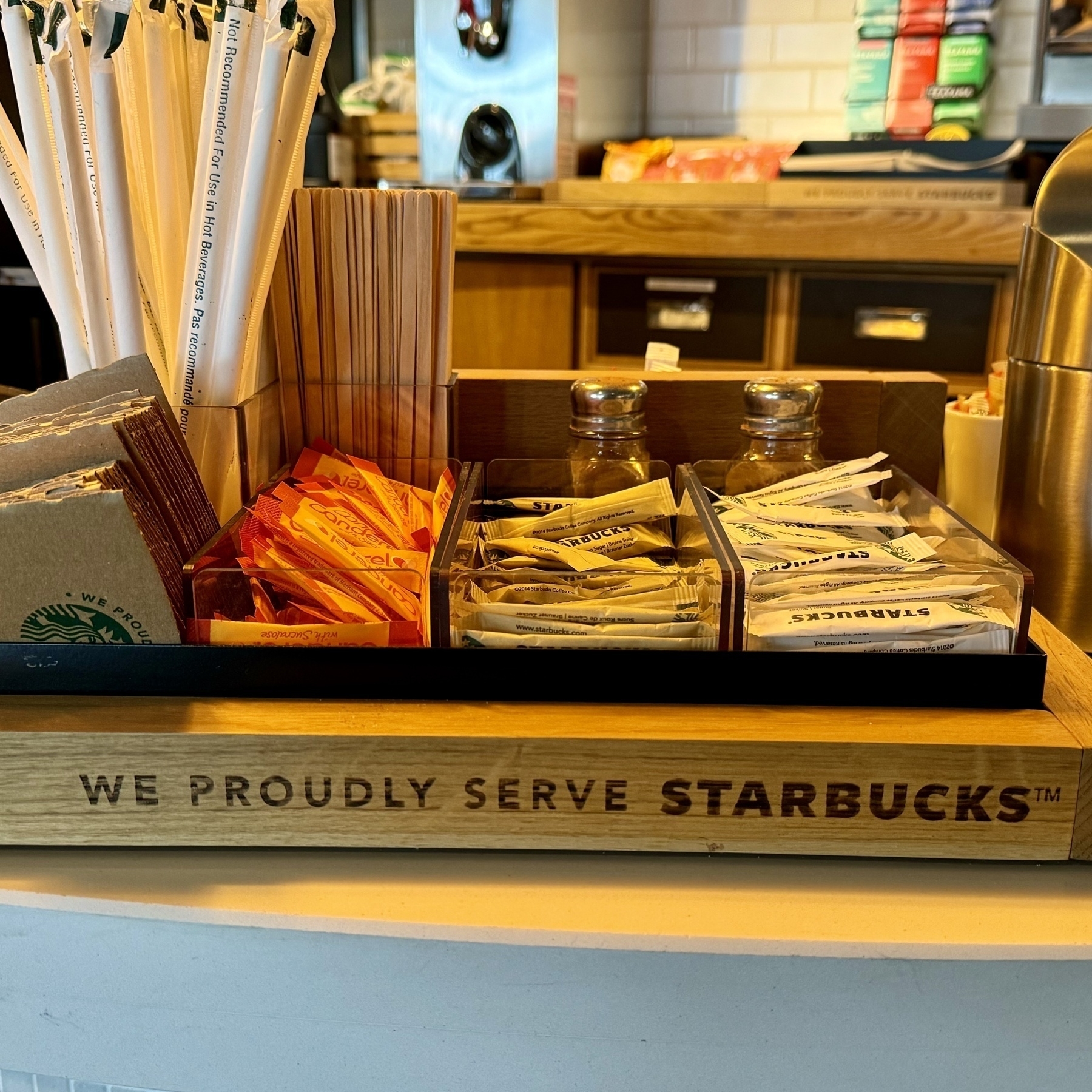 A sign that says the hotel bar “proudly serve Starbucks”