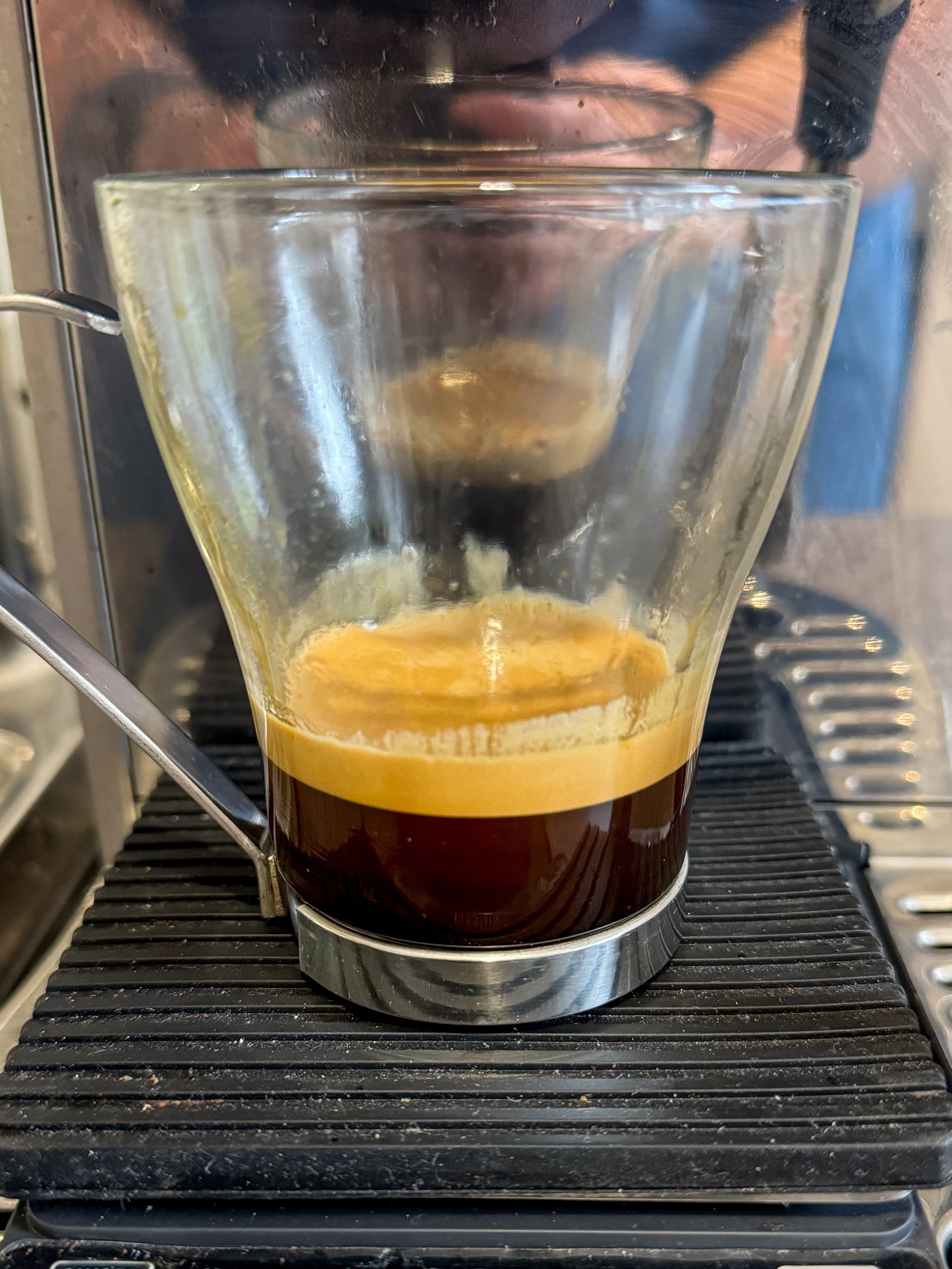 A double shot of espresso coffee in a glass mug.