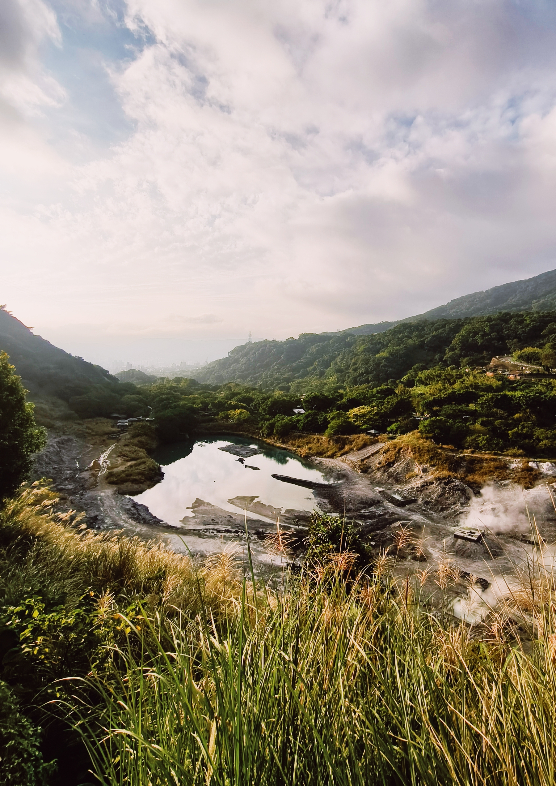 A HDR view from the hills down the alley, with vibrant hont spring water in the front 