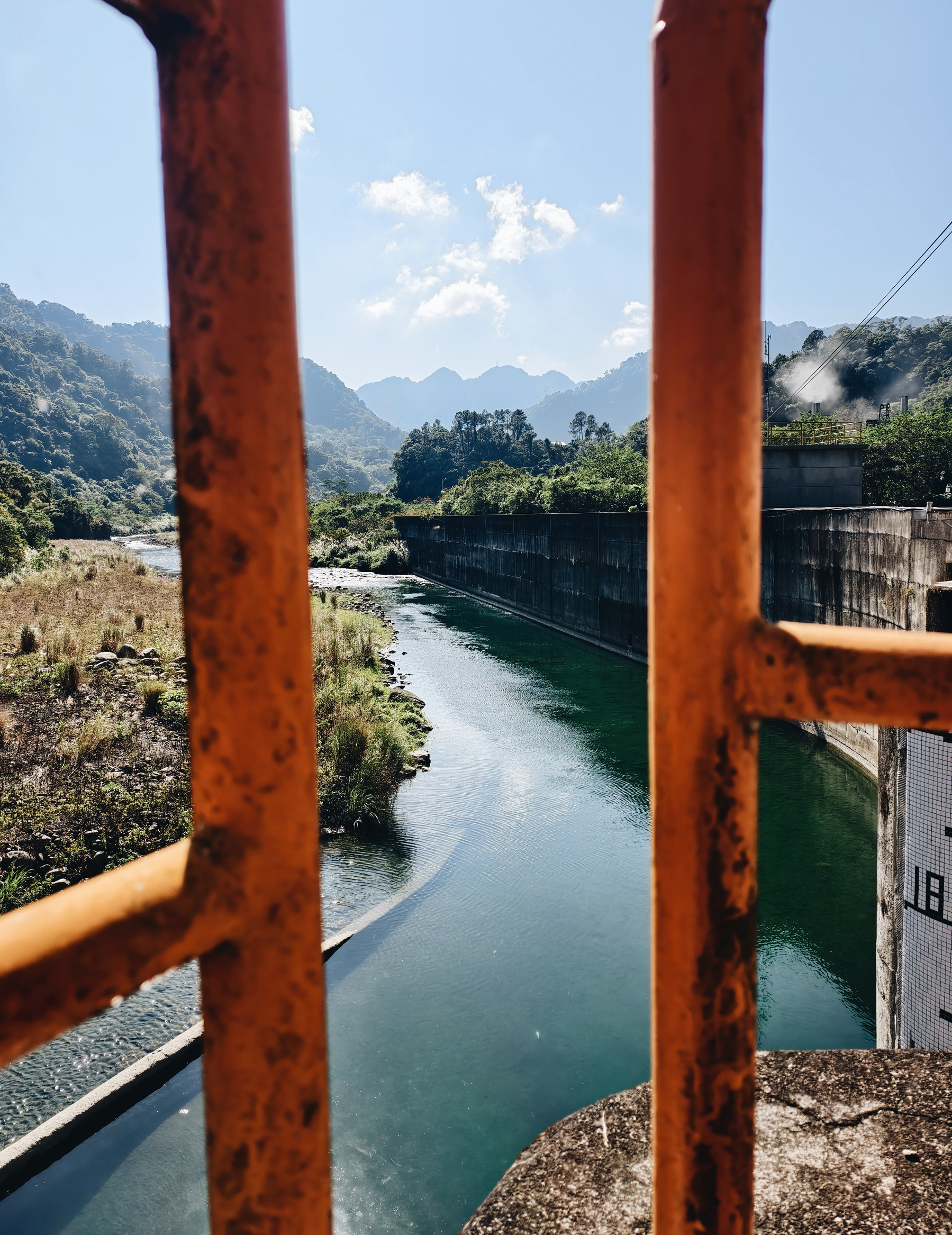A picture of a river, with mountains in the back. So the right, there are four openings, which is where four large pipes guide the water down to the city area. 3 of them are for the Science Park, and half of this will be used by industry for production 