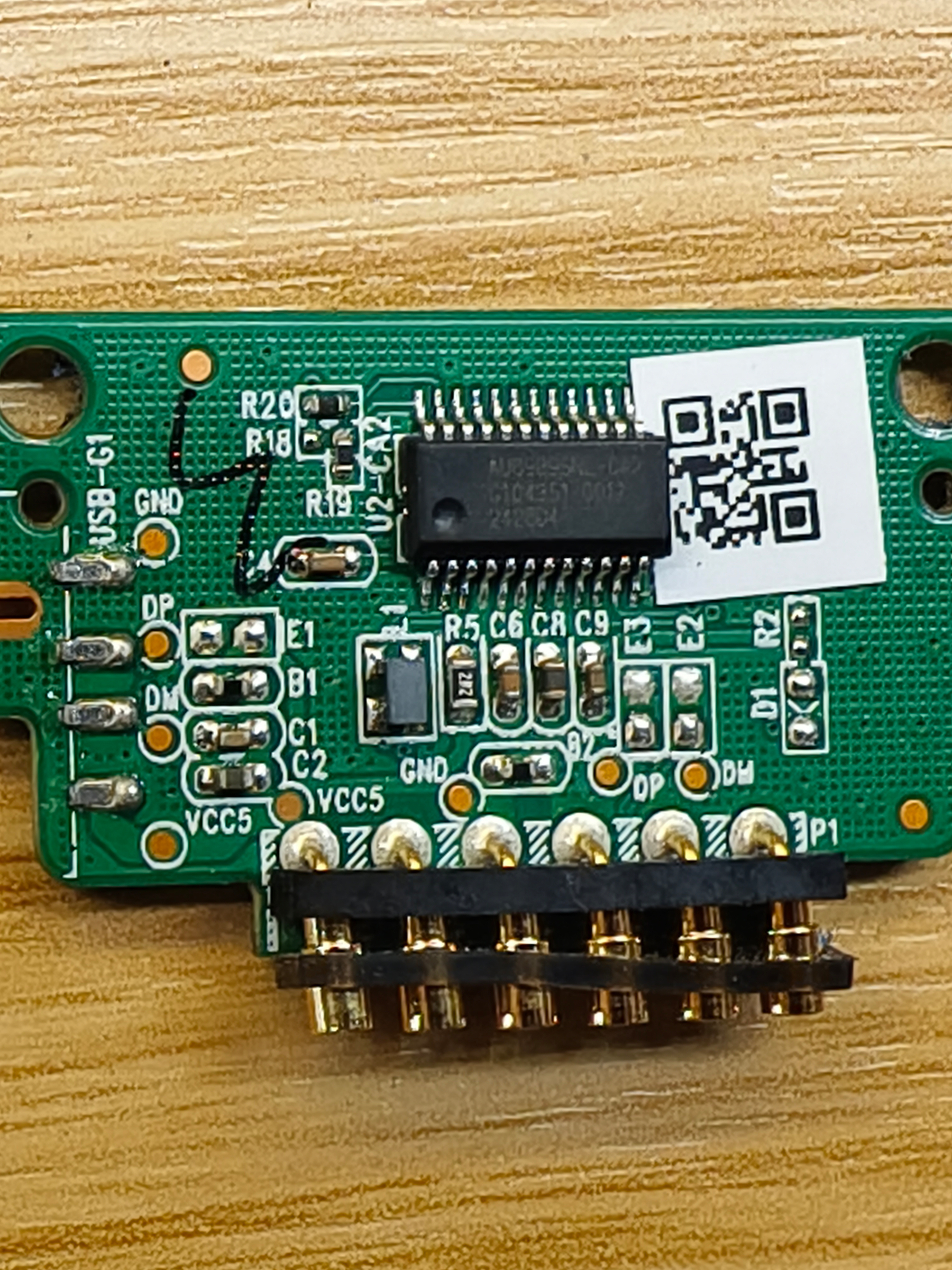 One side of a small printed circuit. Electronics and pins and an ID to trace the chip. A QR code from production.&10;&10;This is the only chip running the token. It includes tracks and every token has only a small set of songs or stories. On the storage device, there's only a few GB. Yet maybe there's room to load more and different stuff on this 🤫