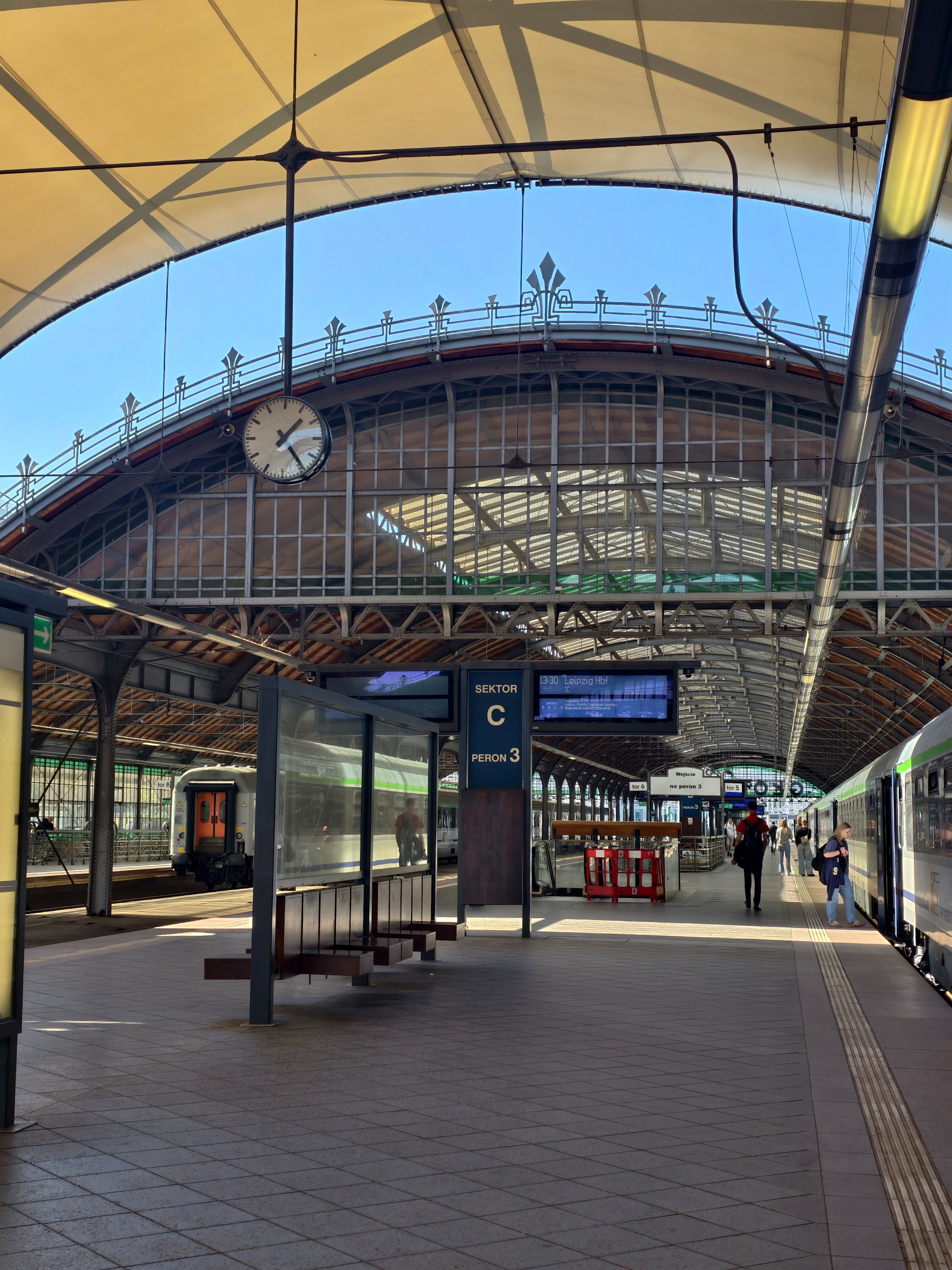 Snapshot from Wroclaw station, where we stopped to say goodbye to the restaurant part of the train that is not allowed to travel to Germany. Old railway station, charming, blue sky.