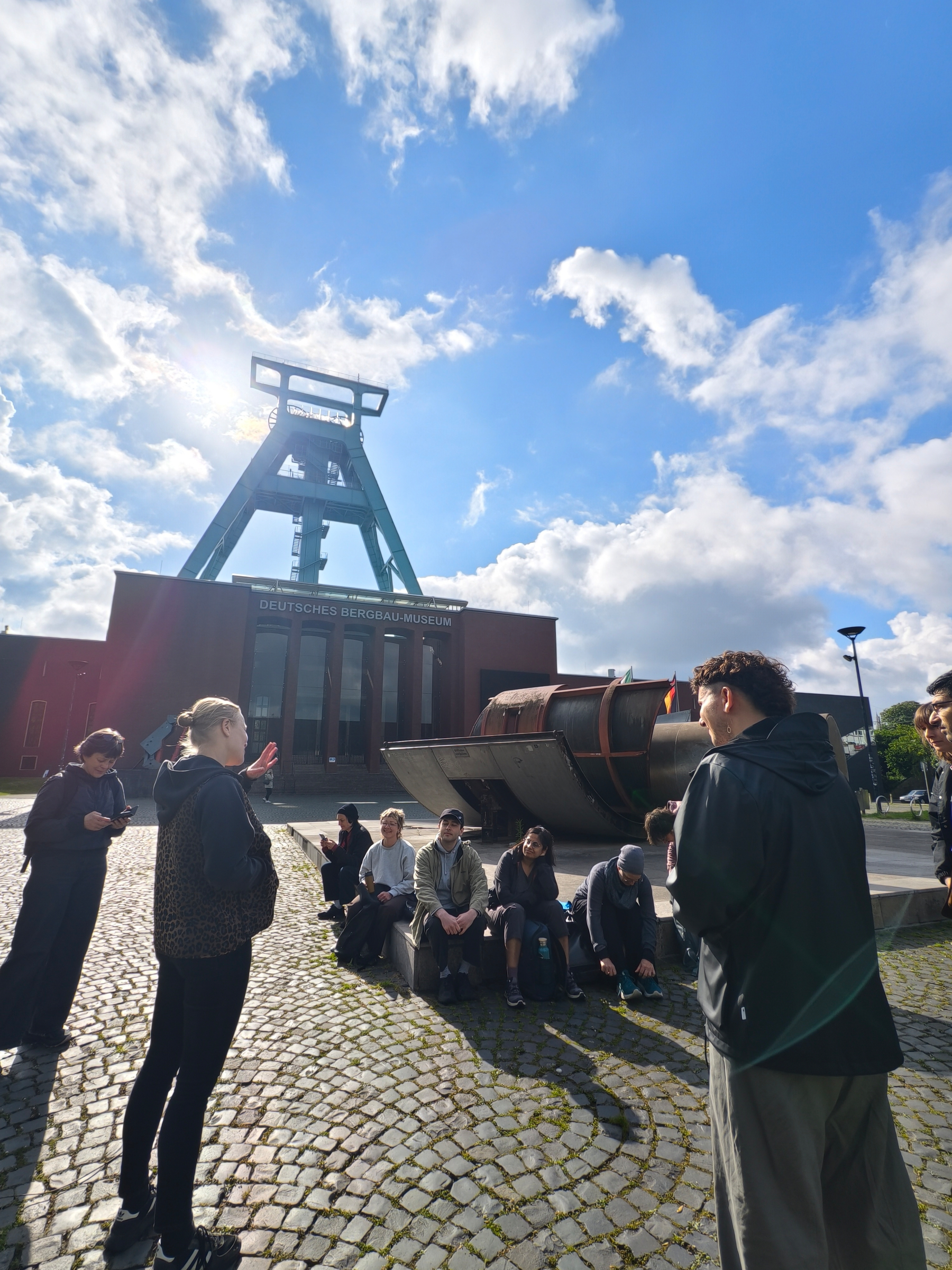 Waiting in front of the German Mining Museum in Bochum is one part of our workshop crowd, the iconic ⛏️ tower in the backy it's sunny. We jumped into various cars soon after