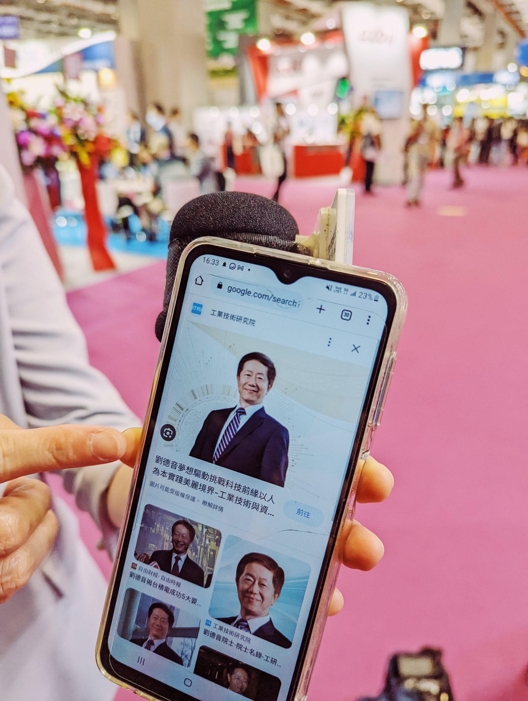 One of the images used in the article, a snapshot from the Taipei industry fair where a journalist showed me an image of the (now former) chairman of TSMC, the star of the industry, that was just rushed through the venue.