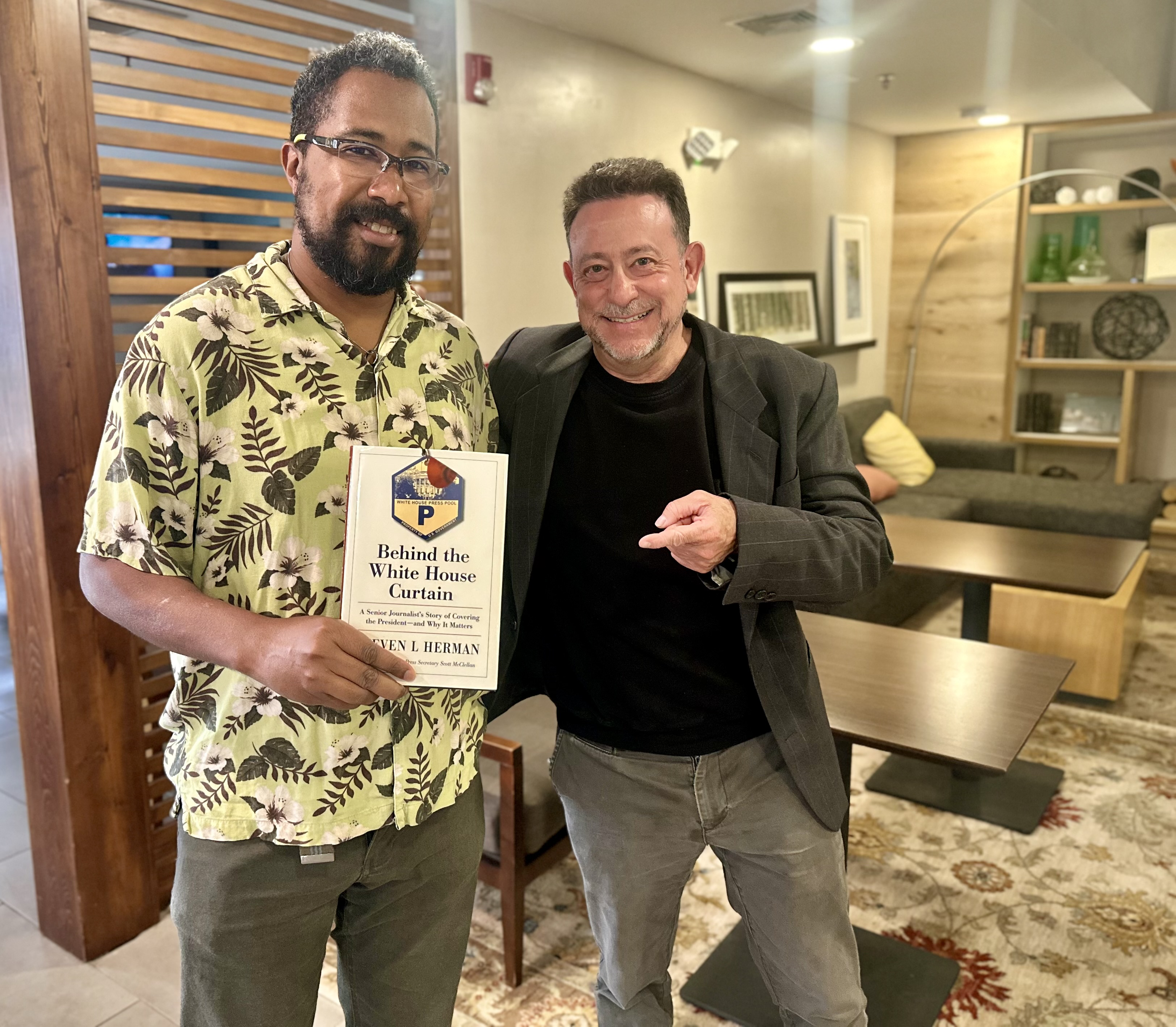 Two men are standing together (J L Gatewood & Steve Herman) in a room, with one holding a book titled "Behind the White House Curtain" by Stephen L. Herman (the guy on the right).