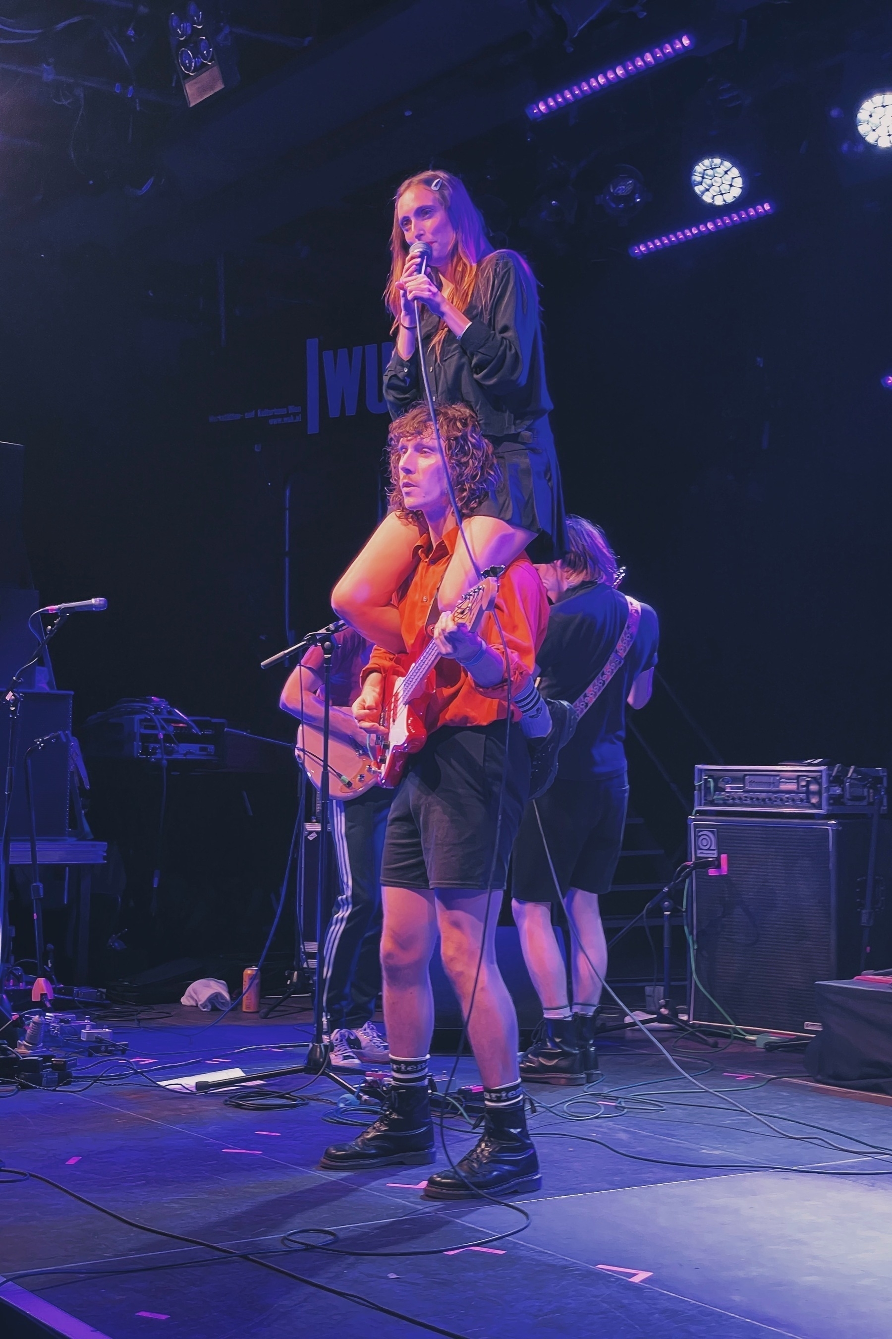 Singer sitting on the shoulders of the bassist