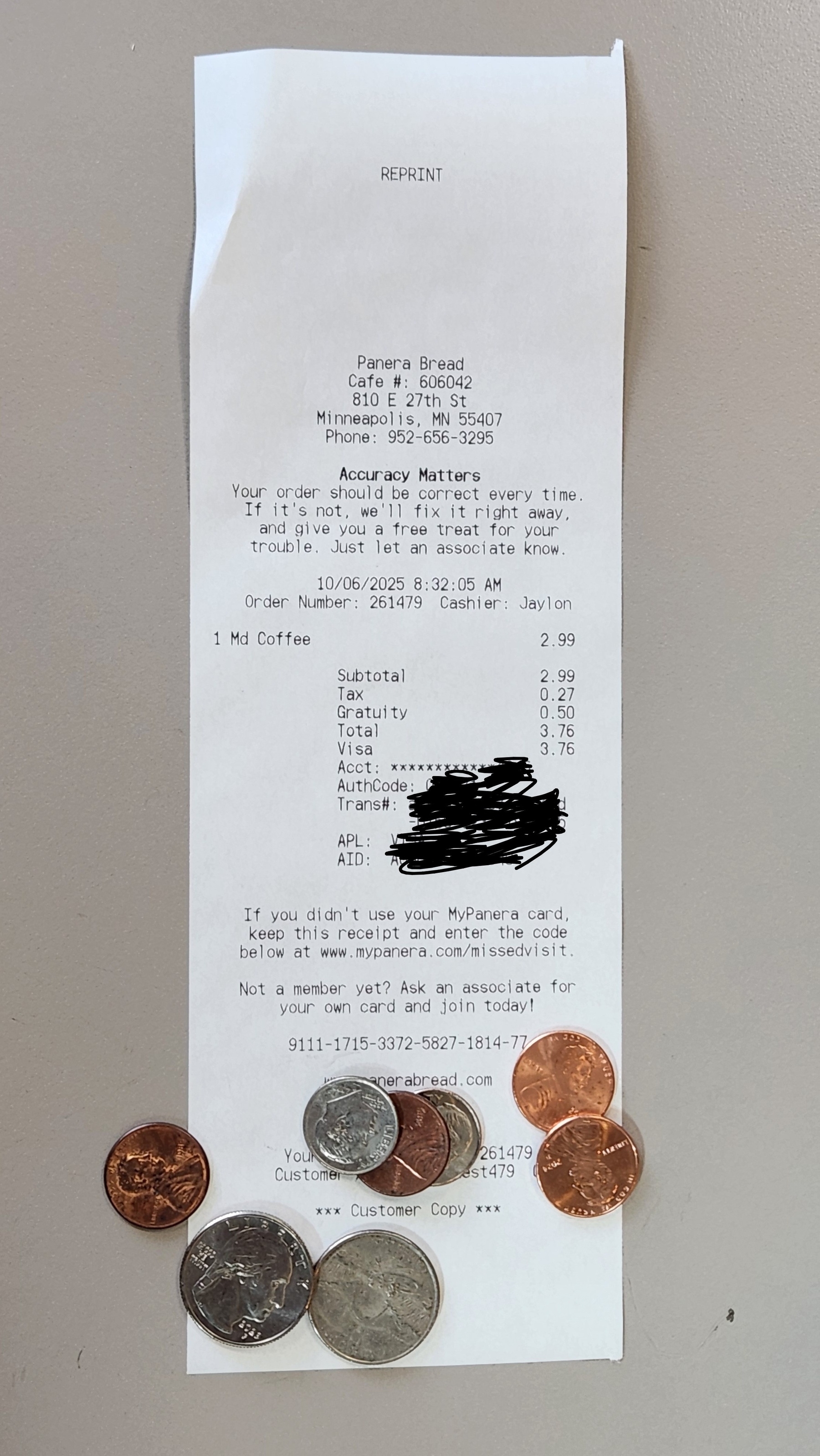 Paper receipt with a small pile of coins atop.