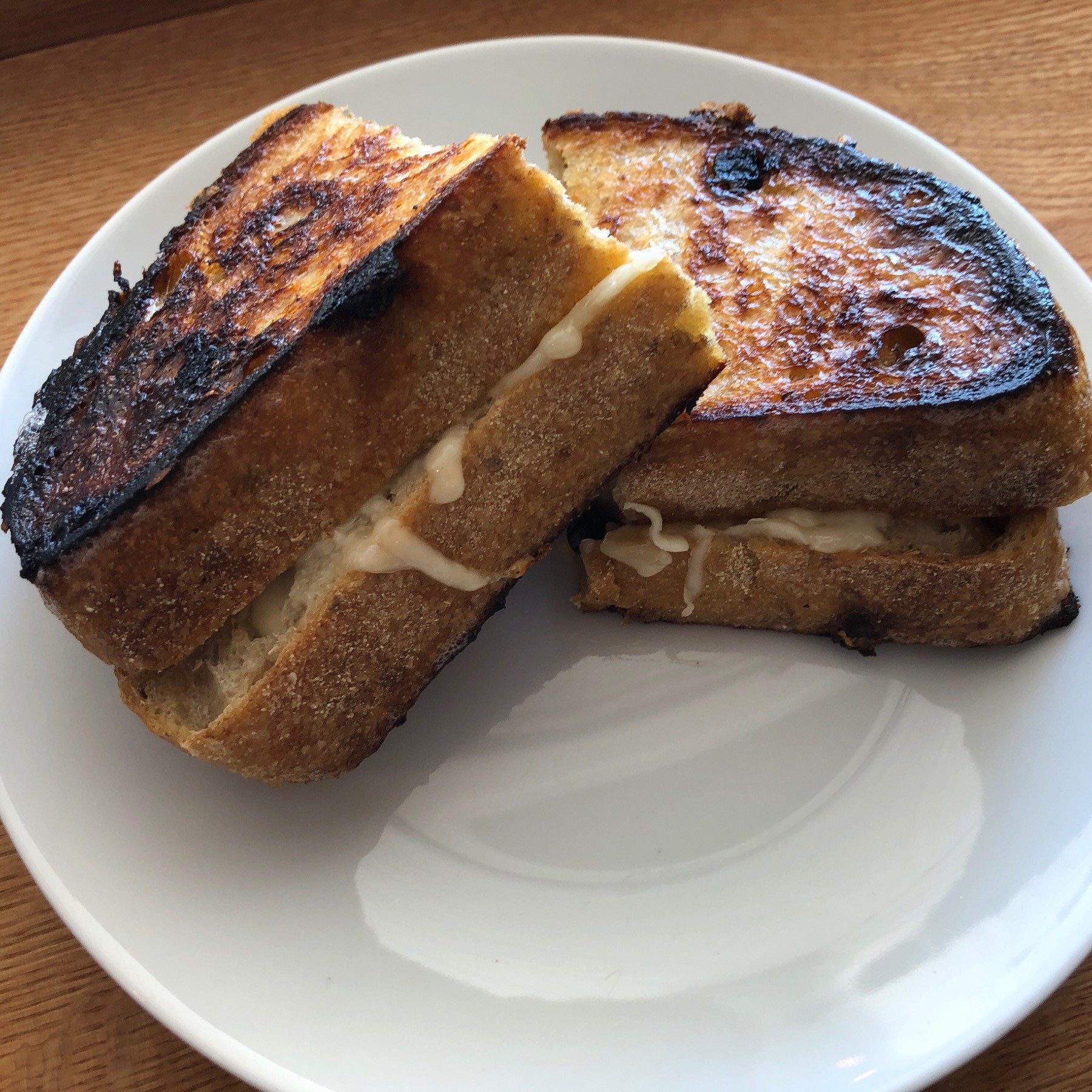 Grilled cheese sandwich on plate.