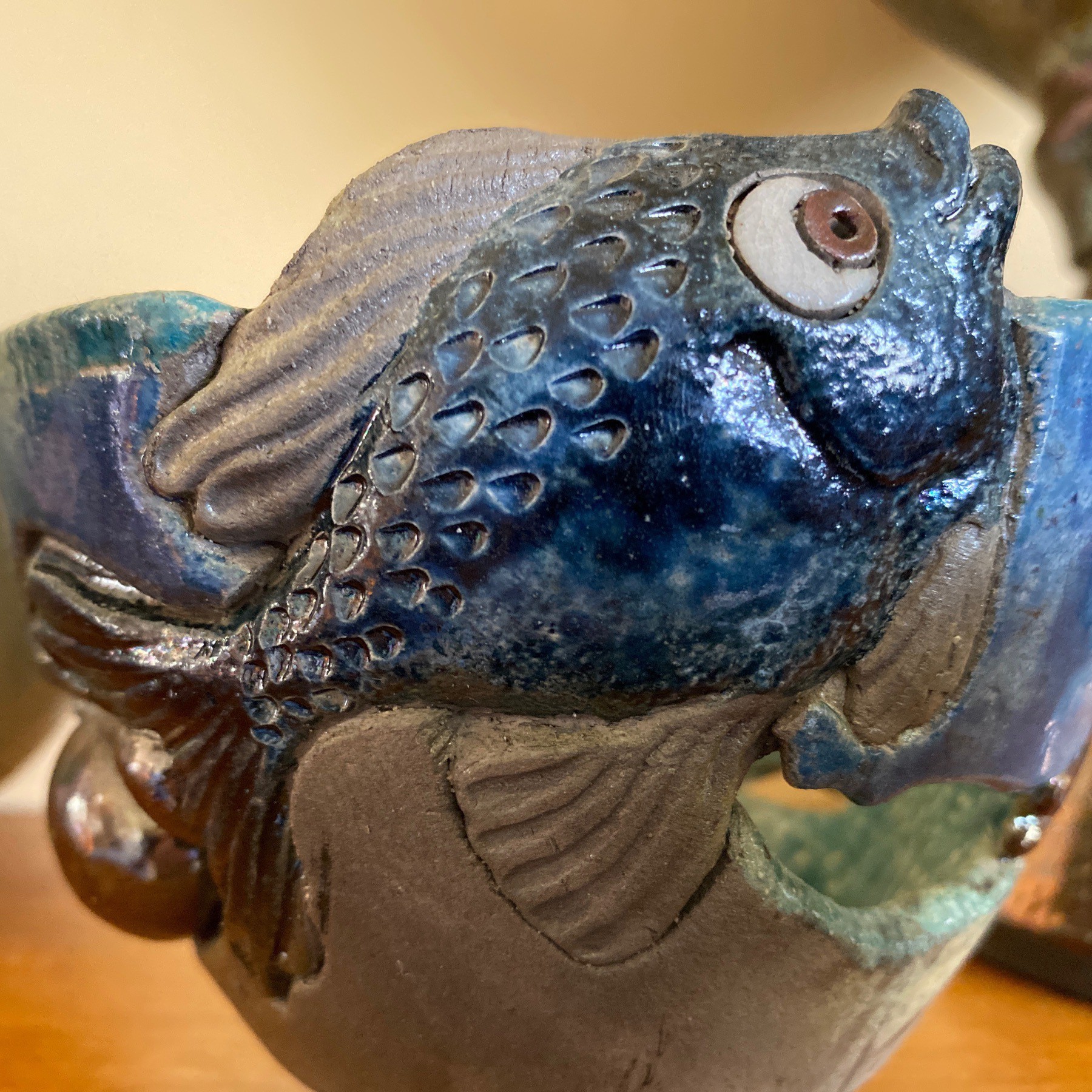 Fish on side of handmade bowl.