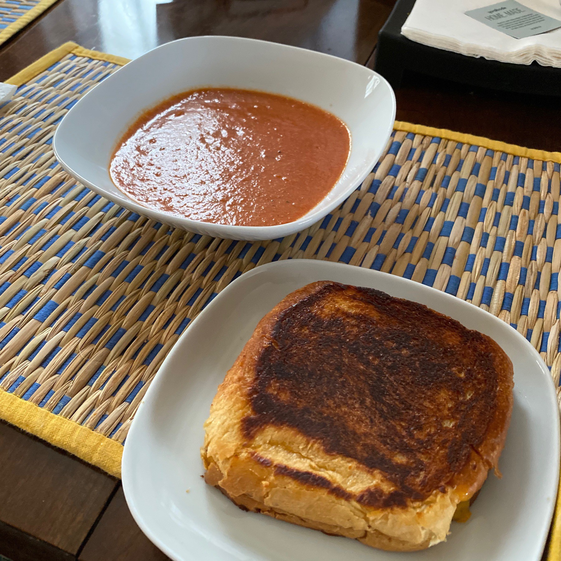 Grilled cheese sandwich and bowl of tomato soup.
