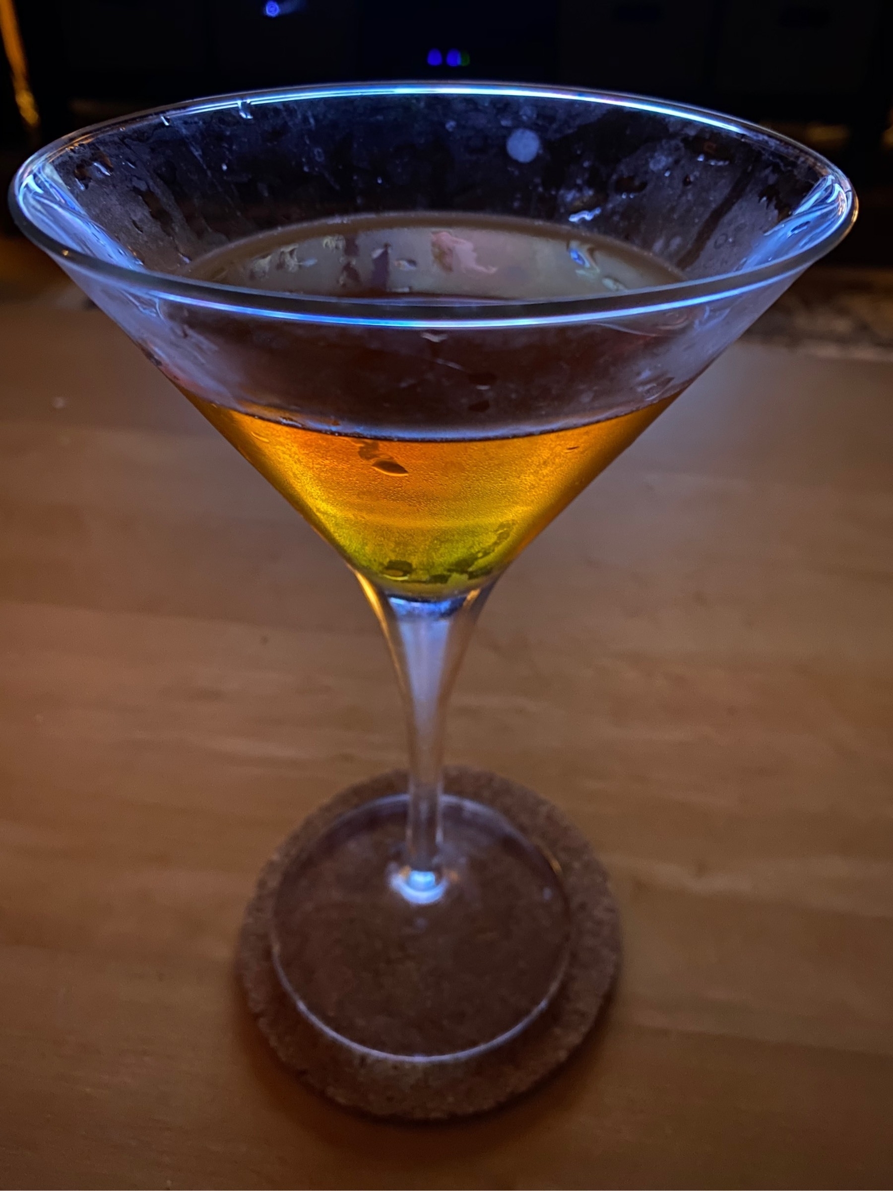 Martini in a martini glass on a wooden table. 