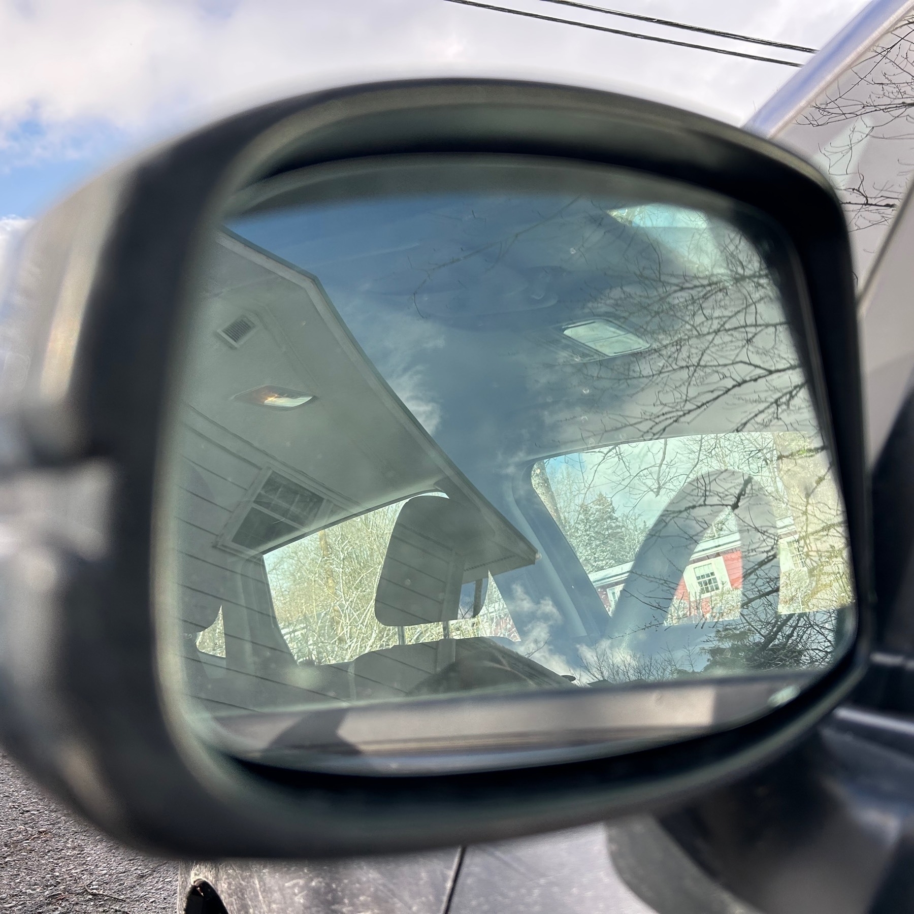 Car mirror with reflection into the car visible. 