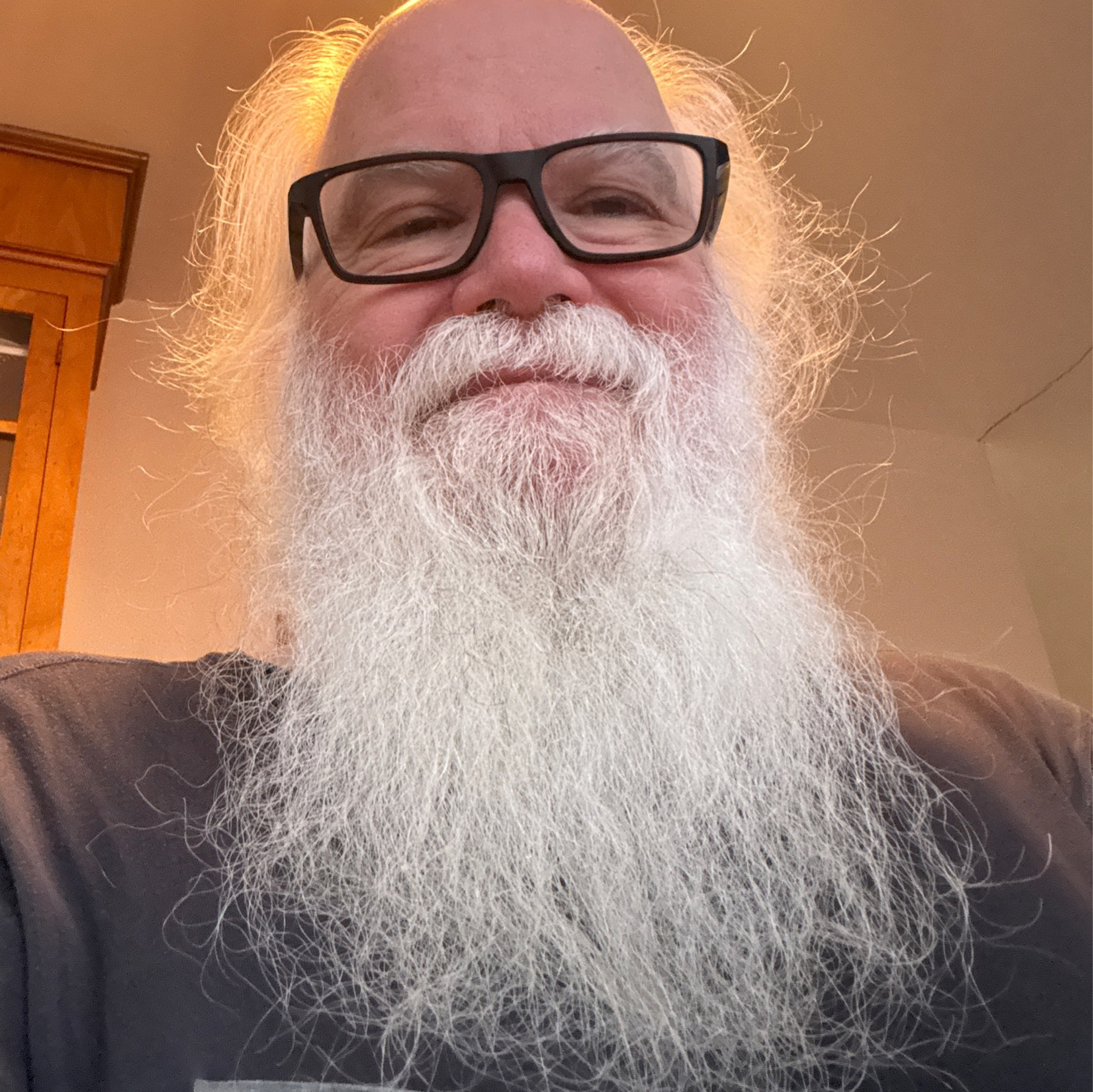 Older man with glasses and large, white beard. 