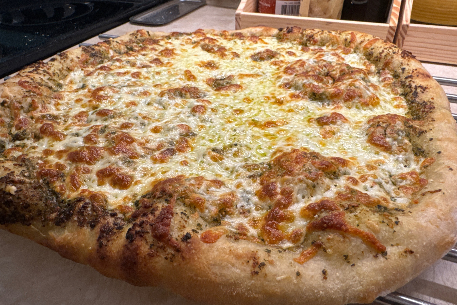 Browned cheese on a pizza on a counter. 