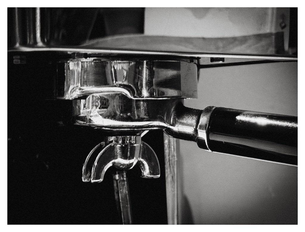 Detail of an espresso machine in black and white. 